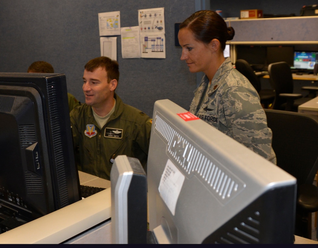 Col. Dave Smith, 601st Air Operations Center Air Mobility Division chief, reviews mobility and airlift documents with Maj. Sarah Boone, Director, Mobility Forces team member. From providing specialized job personnel and equipment to assigning staging areas for supplies, Air Forces Northern, the air component of U.S. Northern Command, continues to assist that command’s support of the Federal Emergency Management Agency’s Hurricane Florence relief efforts. (Air Force photo by Mary McHale)