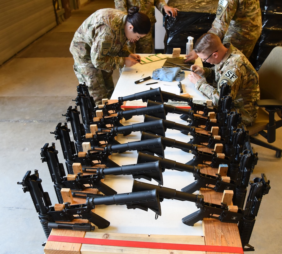 Members assigned to the 28th Security Forces Squadron combat arms training and maintenance flight, inspect M4 carbines at Ellsworth Air Force Base, S.D., Sept. 10, 2018. CATM conducted their biannual inspection of all weapons on base to ensure they are ready for use in a deployed environment and for training purposes. (U.S. Air Force photo by Airman 1st Class Thomas Karol)