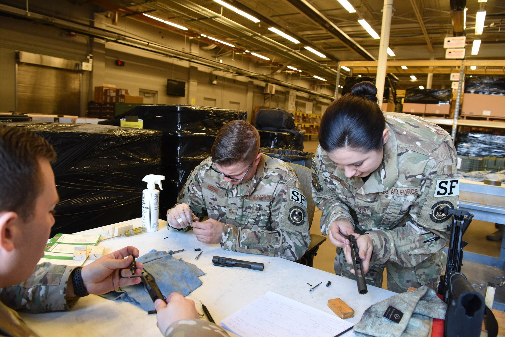 Staff Sgt. Elizabeth Gregson, a 28th Security Forces Squadron combat arms instructor, inspects an M4 bolt carrier at Ellsworth Air Force Base, S.D., Sept. 10, 2018. Members assigned to the 28th Security Forces Squadron combat arms training and maintenance flight conducted their biannual inspection of all weapons on base to ensure they are ready for use in a deployed environment and for training purposes. (U.S. Air Force photo by Airman 1st Class Thomas Karol)
