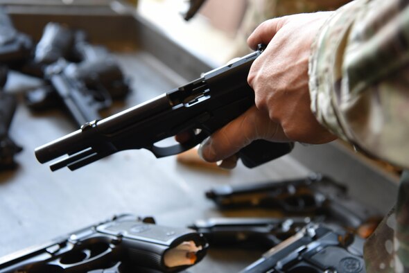 Senior Airman Hayden Wilson, a 28th Security Forces Squadron combat arms instructor, checks an M9 pistol at Ellsworth Air Force Base, S.D., Sept. 10, 2018. Members assigned to the 28th Security Forces Squadron combat arms training and maintenance flight must ensure all firearms on base are properly maintained and handled.