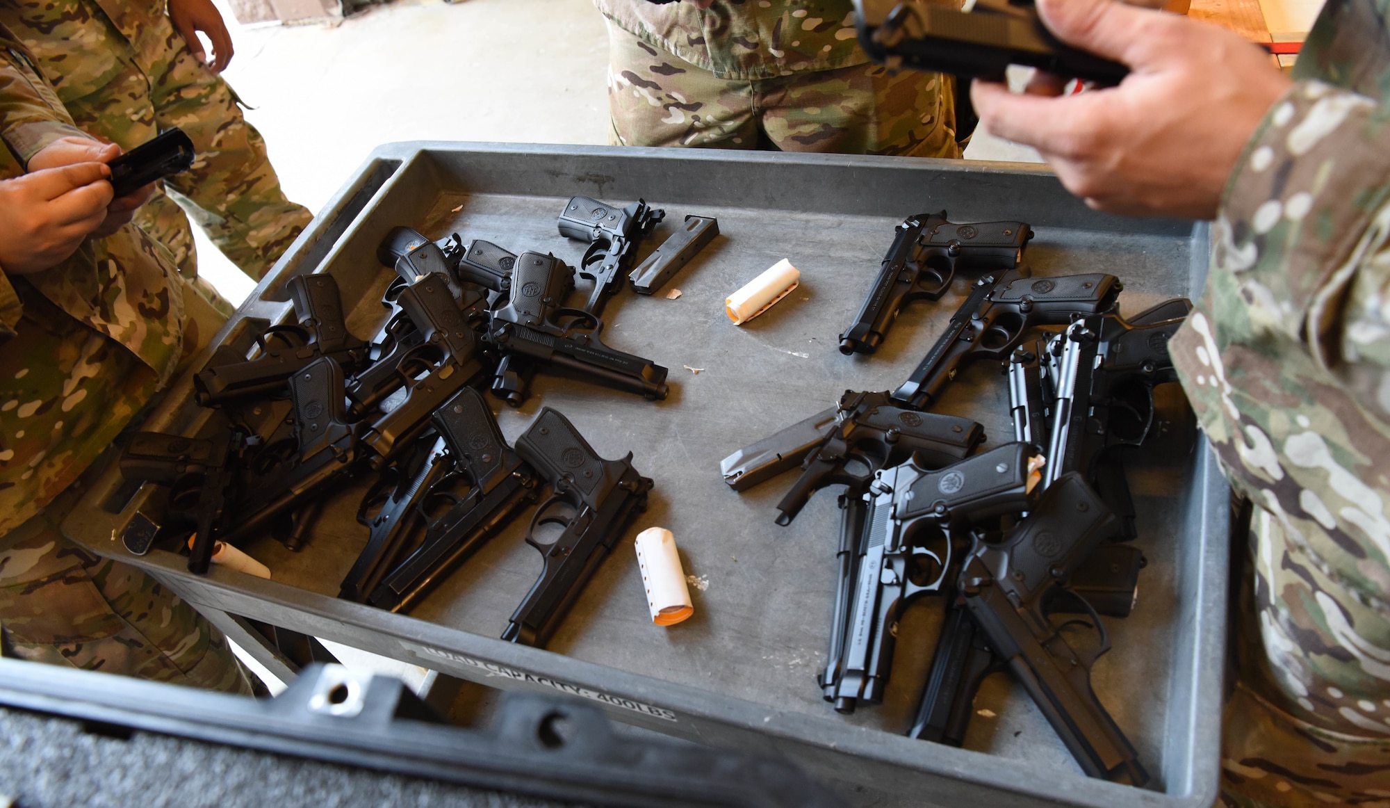 Members of the 28th Security Forces Squadron combat arms training and maintenance flight inspect M9 pistols at Ellsworth Air Force Base, S.D., Sept. 10, 2018. CATM Airmen must ensure all fire arms on base are properly maintained and handled.