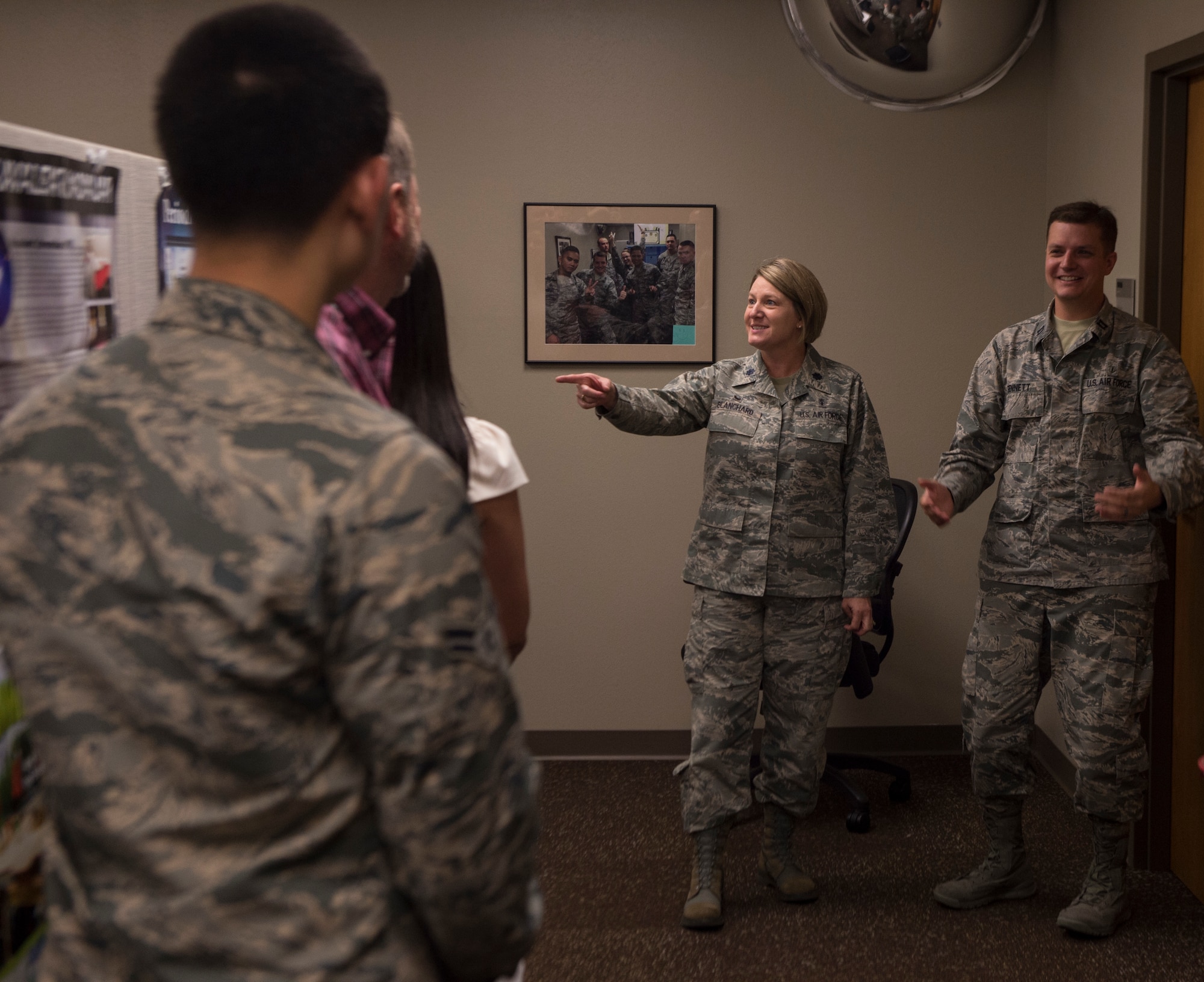 Lt. Col. Janet Blanchard, commander of the 97th Medical Operations Squadron, and Capt. Austin Bennet, commander of the bio-environmental flight, talk to the bio-environmental flight about how they contributed to 1,000 days without a serious safety event September 13, 2018, on Altus Air Force Base, Okla. A serious safety event is any mistake made by medical practitioners that harms a patient.