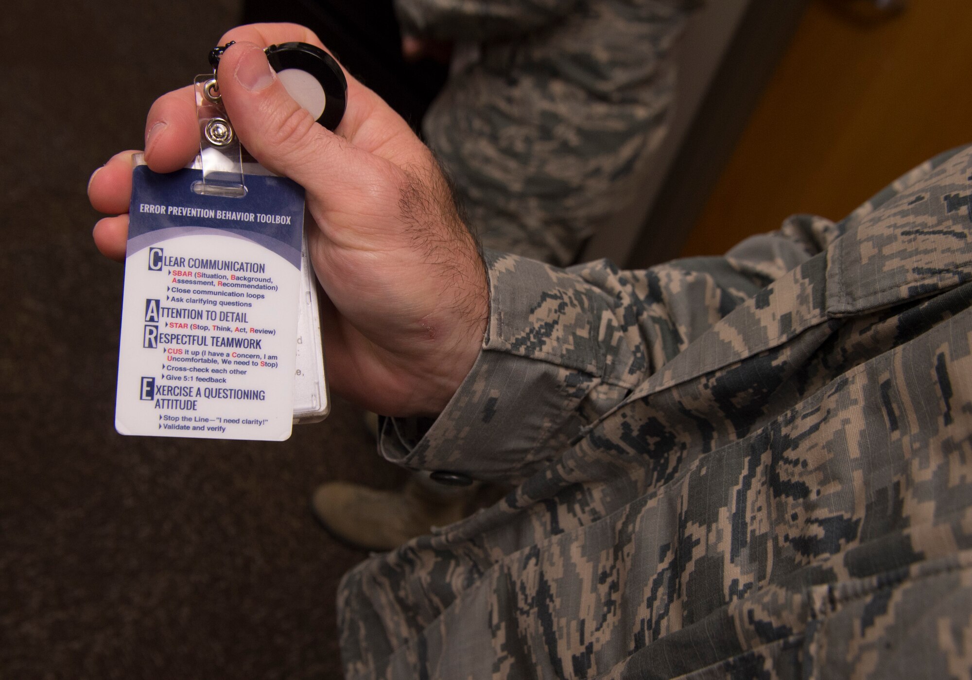 Chief Master Sgt. Justin Helin, the 97th Medical Group superintendent, shows what ID cards in the medical group display and how they contribute to achieving 1,000 days without a serious safety event September 13, 2018, on Altus Air Force Base, Okla. A serious safety event is any mistake made by medical practitioners that harms a patient.