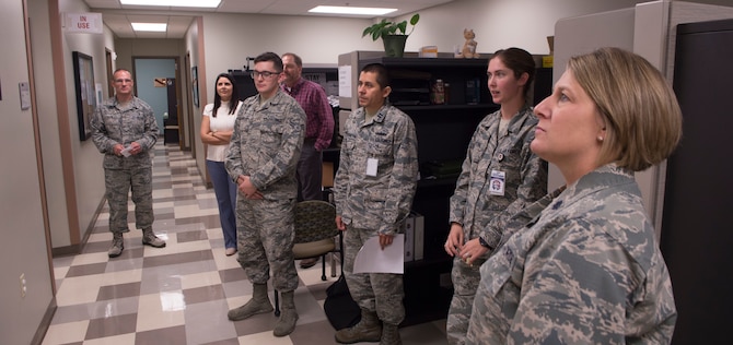 Members of the 97th Medical Group pose with a poster celebrating 1,000 days without a serious safety event September 13, 2018, on Altus Air Force Base, Okla. A serious safety event is any mistake made by medical practitioners that harms a patient.