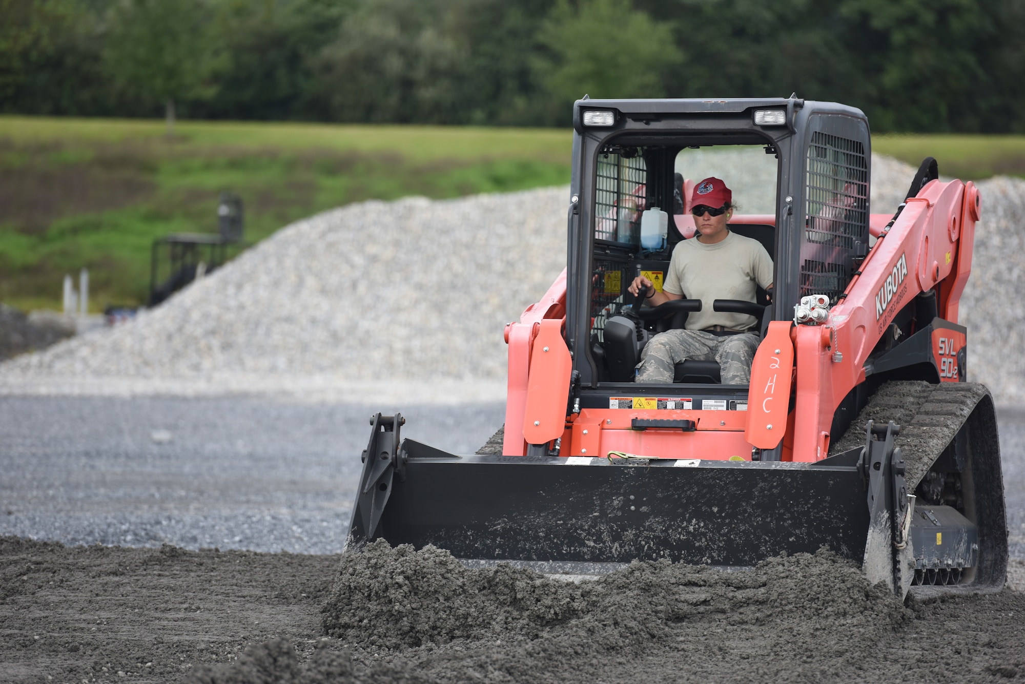 Senior Airman Helene Jones, a heavy equipment operator with the 201st RED HORSE Squadron, Fort Indiantown Gap, Pennsylvania, participates in a field training exercise Sept. 7, 2018. Jones was in charge of evenly distributing 1 1/2 feet of stone that was being laid as the foundation for a K-span building. (U.S. Air National Guard photo by Senior Airman Julia Sorber/Released)