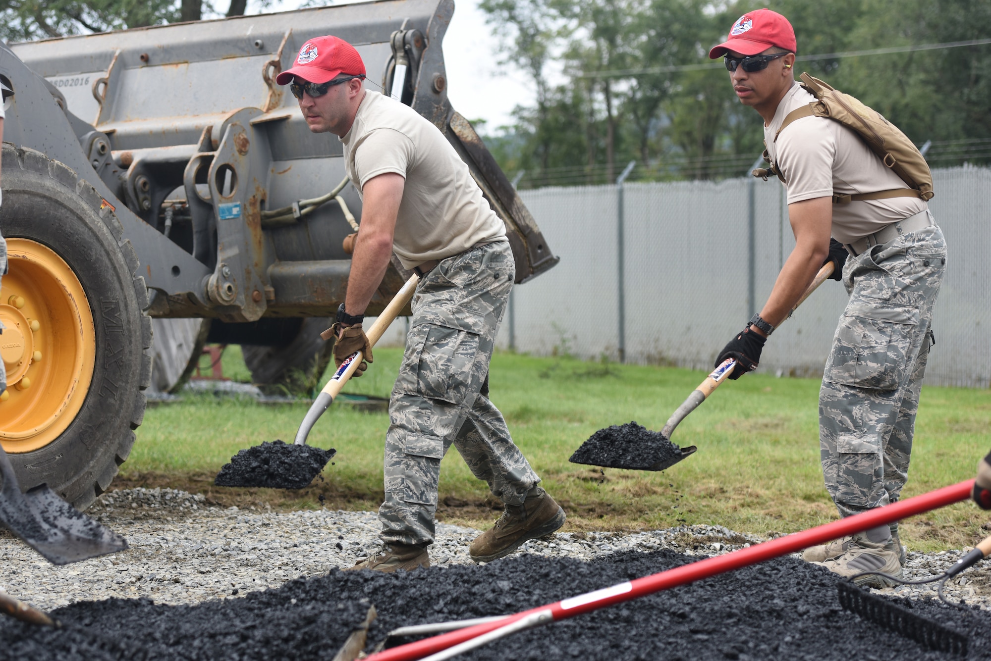 Airmen with the 201st RED HORSE Squadron, Fort Indiantown Gap, Pennsylvania, spread asphalt in preparation for paving a small section on base Sept. 7, 2018. The second day of the field training exercise was focused on specific career field training for eight different Air Force Specialty Codes. (U.S. Air National Guard photo by Senior Airman Julia Sorber/Released)