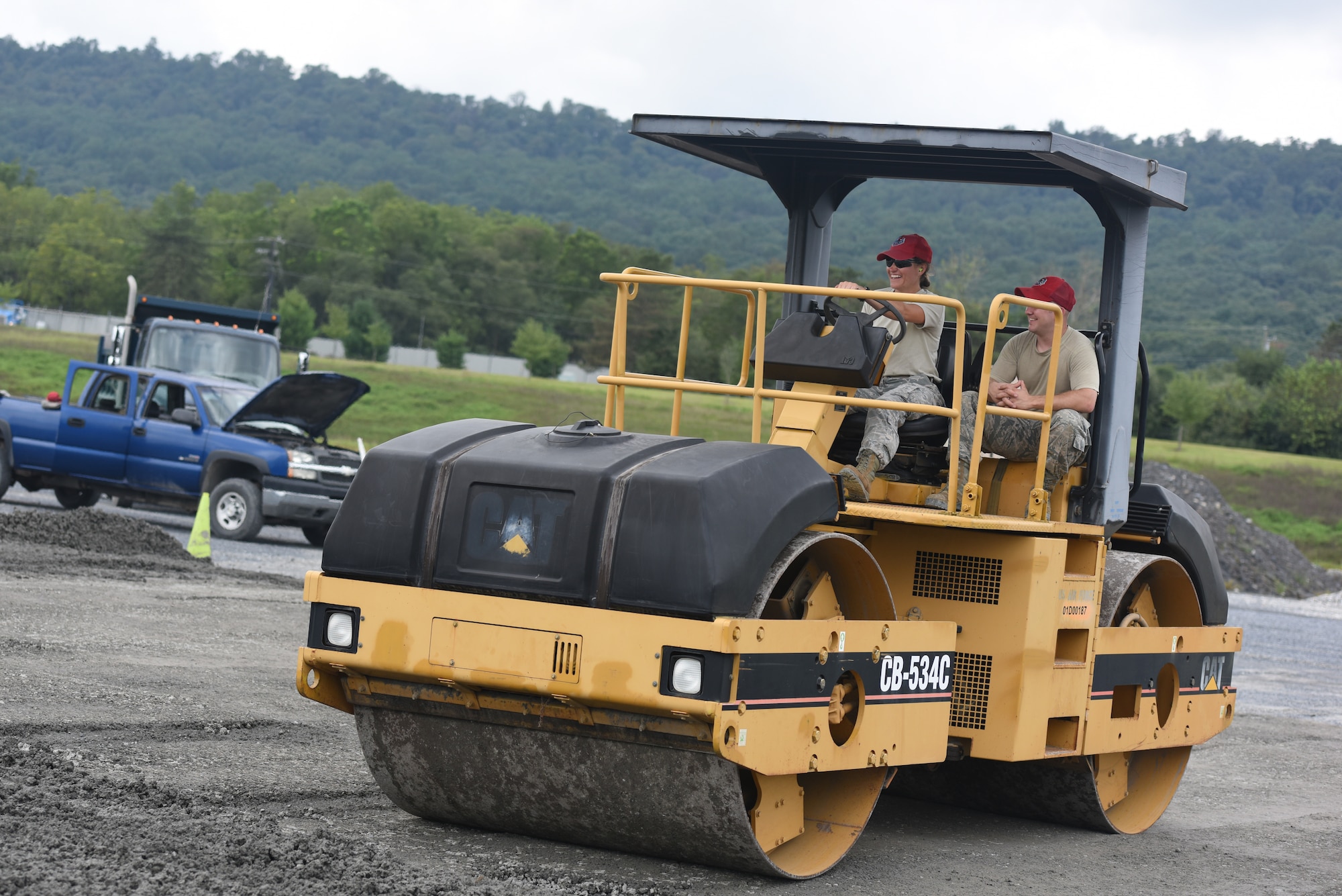 Airmen with the 201st RED HORSE Squadron, Fort Indiantown Gap, Pennsylvania, participate in a field training exercise Sept. 7, 2018. These Airmen were in charge of leveling out the 1 1/2 feet of stone being laid as the foundation for a K-span building. (U.S. Air National Guard photo by Senior Airman Julia Sorber/Released)