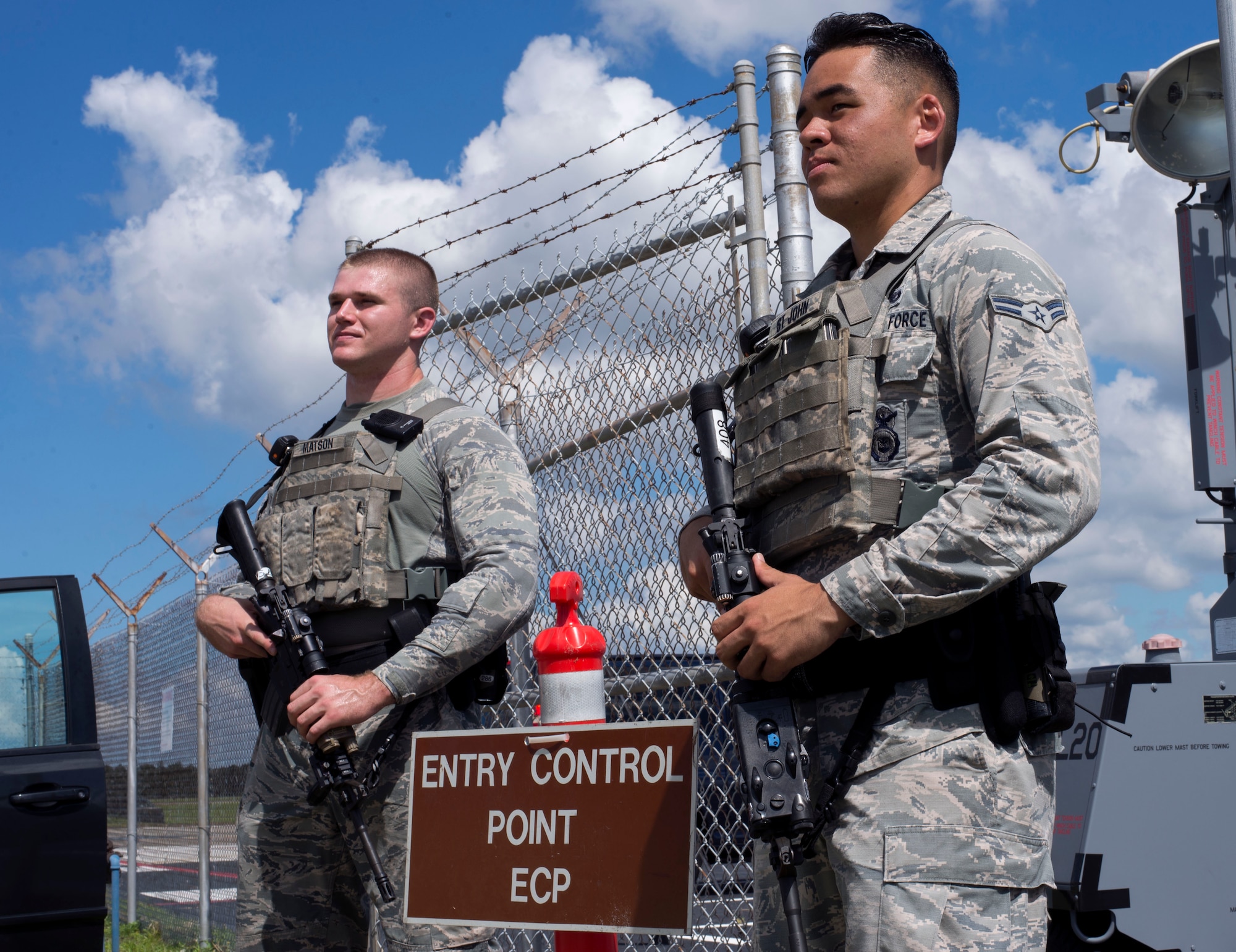 U.S. Air Force Senior Airman Timothy Matson, left, and Airman 1st Class Randall St. John, right, entry controllers assigned to the 6th Security Forces Squadron, watch over a simulated entry control point during an operational readiness exercise at MacDill Air Force Base, Florida, Sept. 13, 2018.