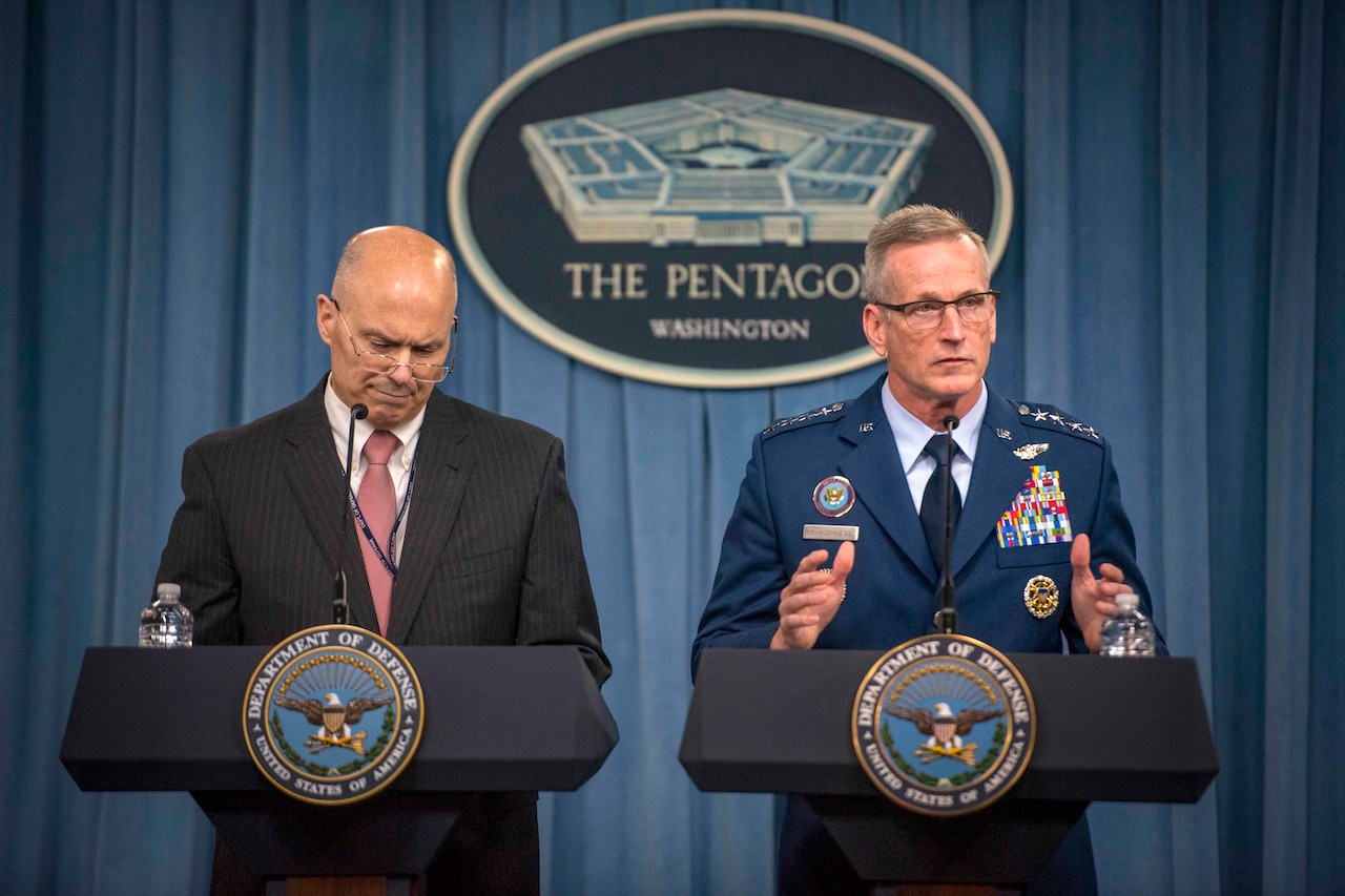 Two officials stand at lecterns..