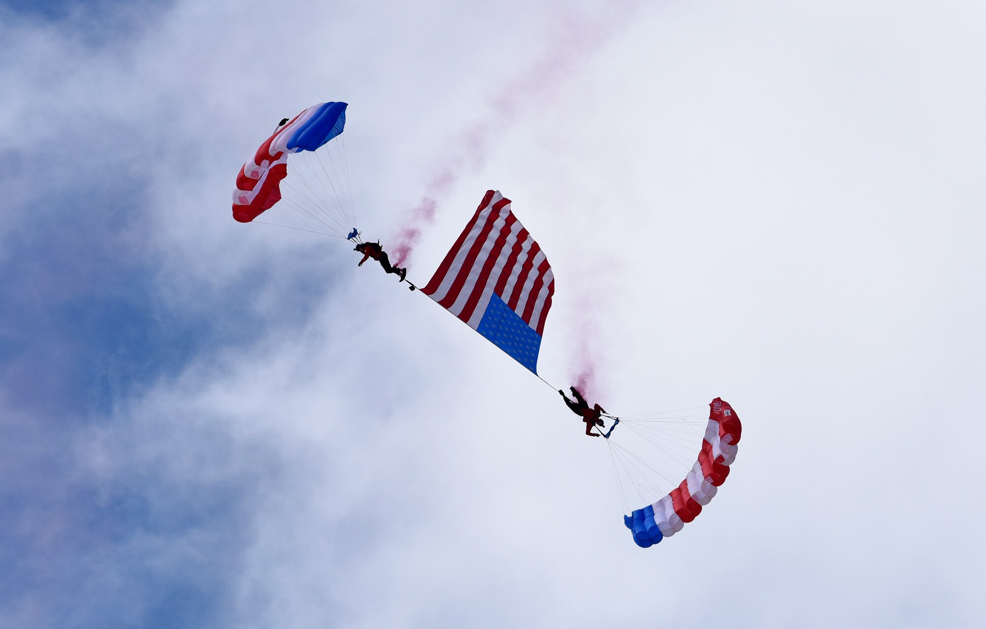 The Patriot Parachute Team performs a skydiving routine at the Frontiers in Flight Open House and Air Show Sept. 9, 2018, at McConnell Air Force Base, Kansas. The team is comprised of five veterans, who learned parachuting from their combat experiences. (U.S. Air Force photo by Airman 1st Class Michaela R. Slanchik)