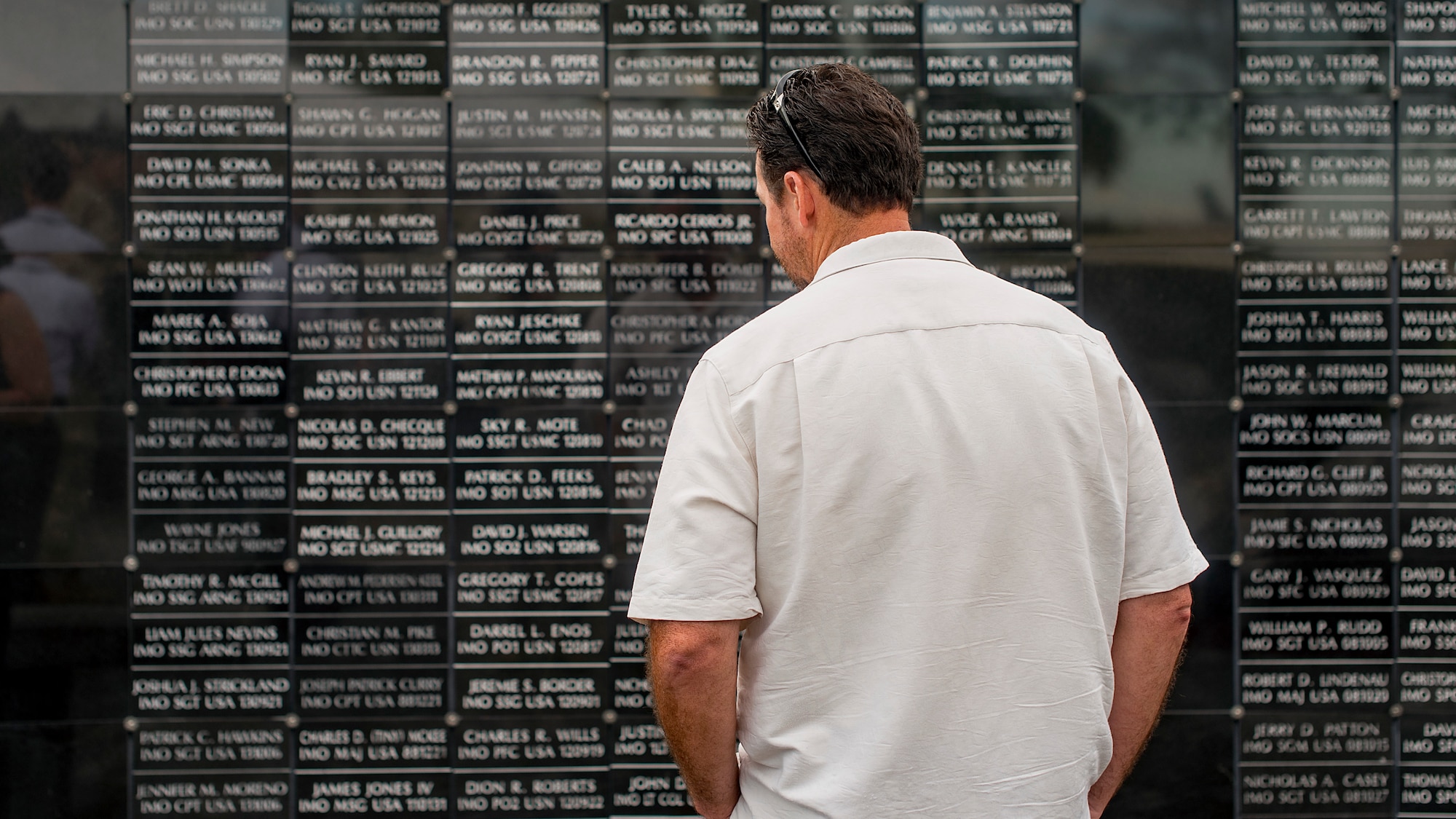 A Team MacDill Member pays respects to the names on the U.S. Special Operations Command Memorial after a 9/11 memorial ceremony held at MacDill Air Force Base, Fla., Sept. 11, 2018. The remembrance ceremony was held in honor of those who died during the attacks.