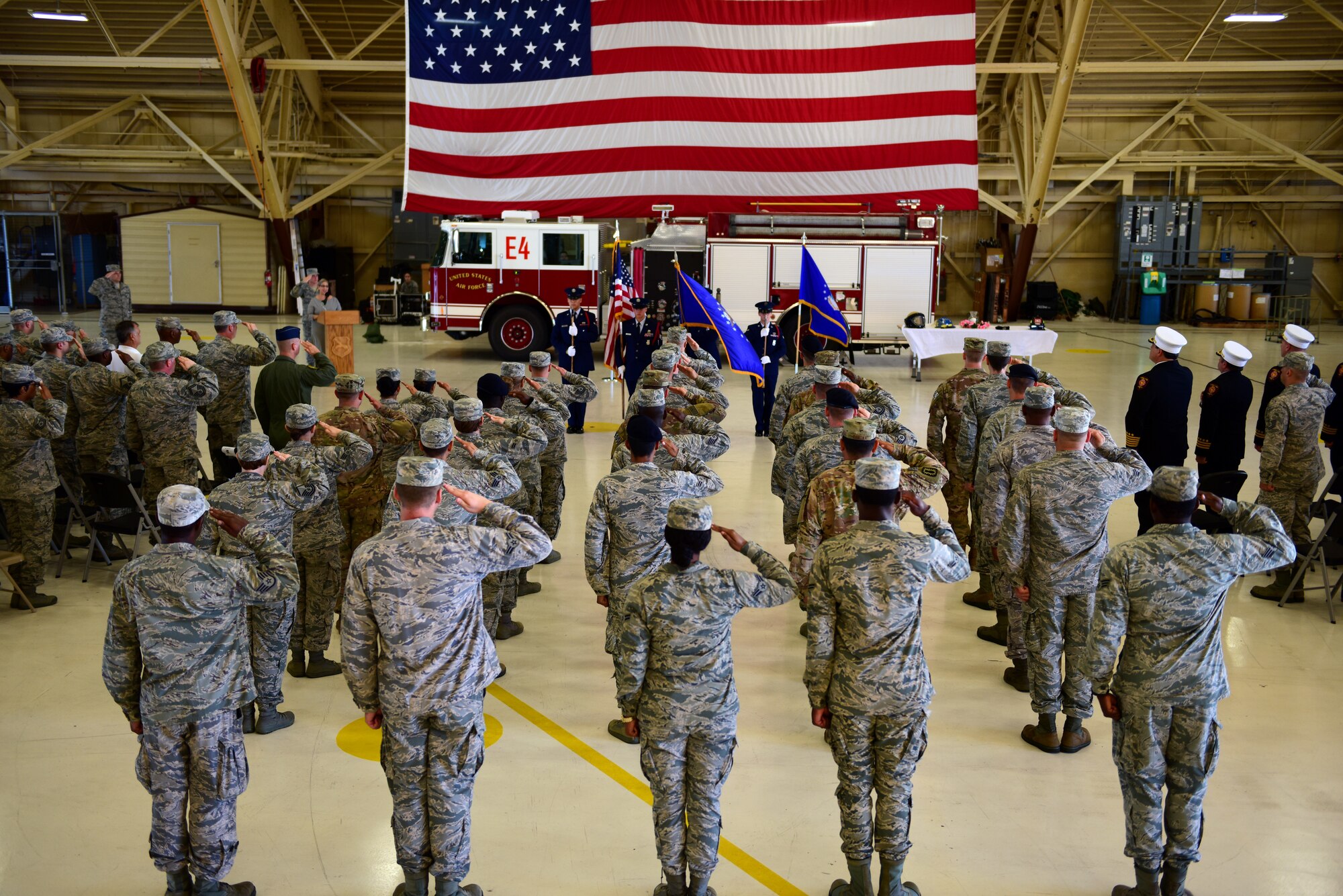 Attendees and Airmen from the 325th Fighter Wing render salutes and proper courtesies during a 9/11 remembrance ceremony at Tyndall Air Force Base, Fla., Sept. 11, 2018. Every year Americans gather to remember and honor the nearly 3,000 people killed in the World Trade Center, Pennsylvania, and Pentagon terrorist attacks. (U.S. Air Force photo by Senior Airman Isaiah J. Soliz)