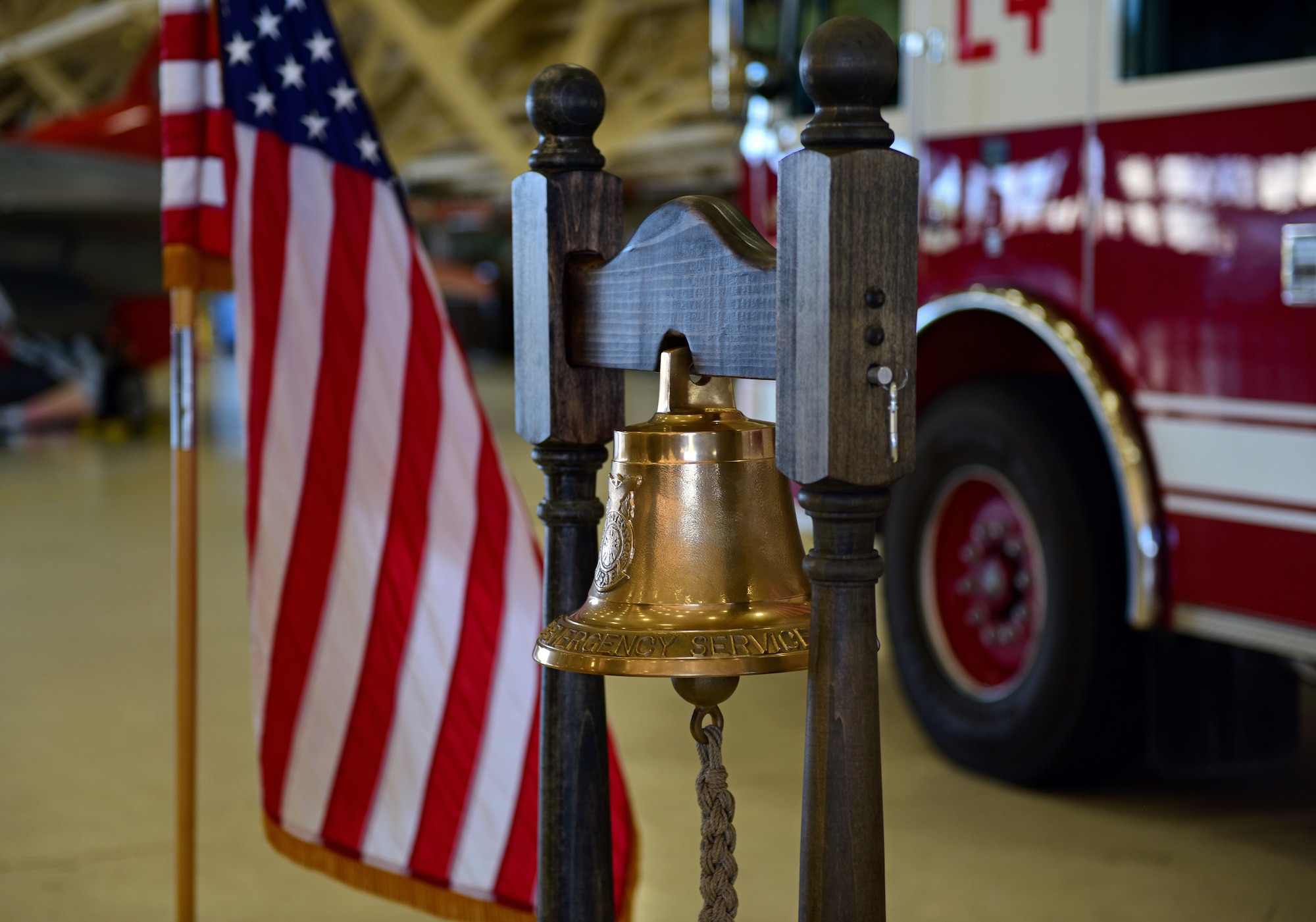 A ceremonial bell is positioned near the U.S. Flag prior to a 9/11 remembrance ceremony at Tyndall Air Force Base, Fla., Sept. 11, 2018. The 325th Civil Engineer Squadron hosted the first base-wide ceremony that included speeches from Col. Brain Laidlaw, 325th Fighter Wing commander, and Donald Arias, 325th FW Public Affairs chief. Every year Americans gather to remember and honor the nearly 3,000 people killed in the World Trade Center, Pennsylvania, and Pentagon terrorist attacks. (U.S. Air Force photo by Senior Airman Isaiah J. Soliz)