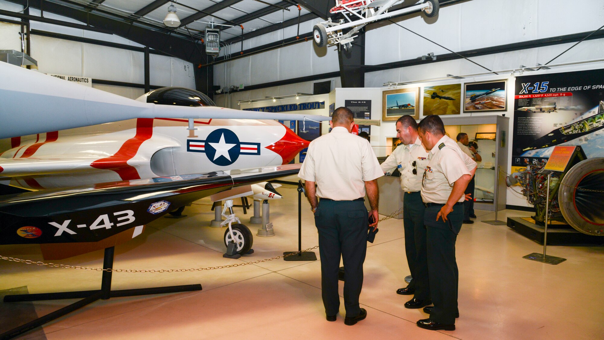 Members of the Colombian and Brazilian air forces check out an X-43 during their visit to the museum at Edwards Air Force Base, California, Sept. 10, 2018. During their visit, the delegation received briefs on the overall mission of Edwards and toured various base facilities. (U.S. Air Force photo by Giancarlo Casem)