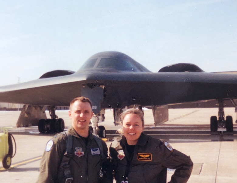 U.S. Air Force Capts. John and Jennifer Avery smile for a photo in front of the B-2 Spirit at an Whiteman Air Force Base, Missouri. The Averys were the first husband-wife team to fly the B-2. The couple served with the 509th Bomb Wing at Whiteman AFB and then with the base’s Missouri National Guard 131st Bomb Wing. Their shared military careers culminated at their joint retirement ceremony Sept. 7, 2018, at Whiteman AFB. The couple has two children, Austin and Elizabeth, and live in Boise, Idaho. (Photo courtesy of the Avery family)