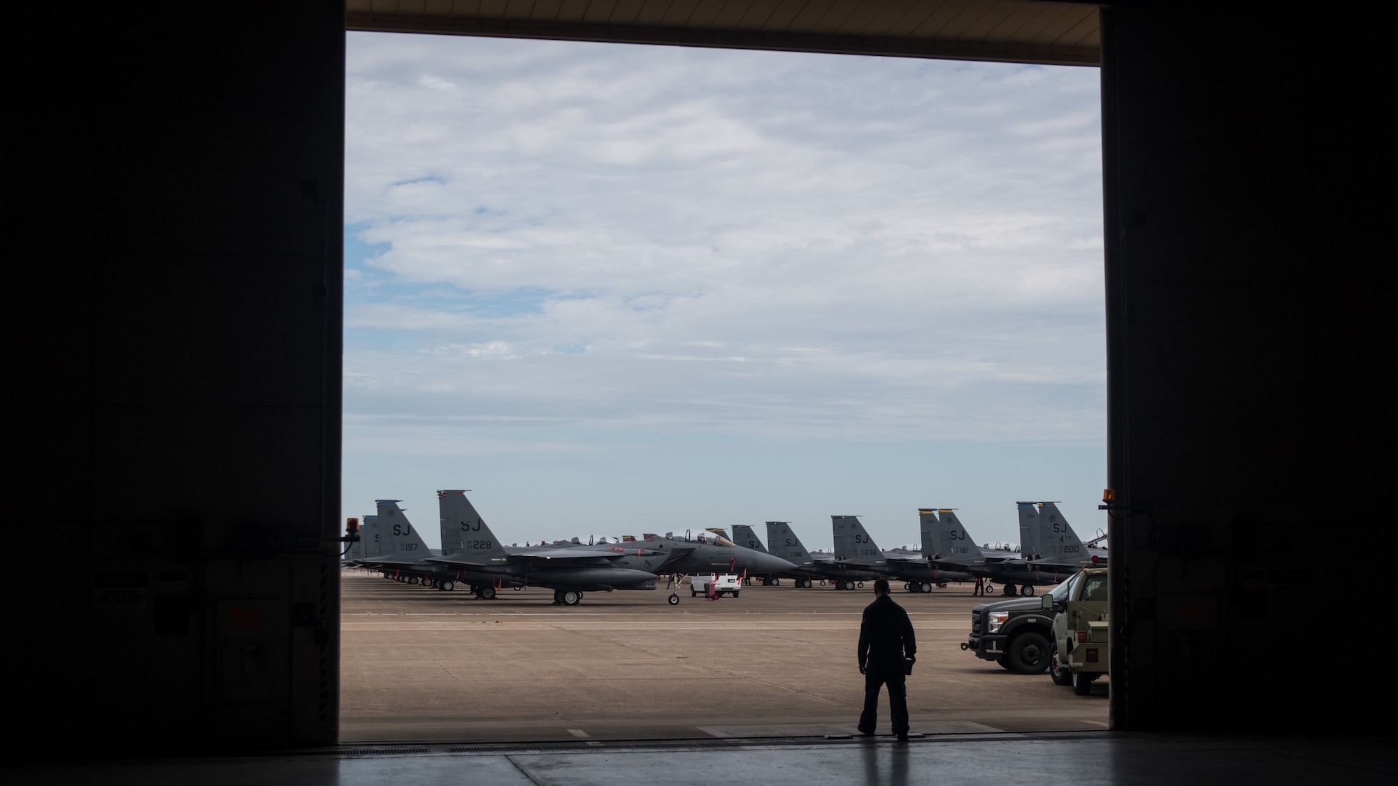 A maintainer from Seymour Johnson Air Force Base, North Carolina, walks toward the flightline at Barksdale Air Force Base, La., Sept. 13, 2018. The aircraft evacuated to Barksdale to avoid possible damage from Hurricane Florence.