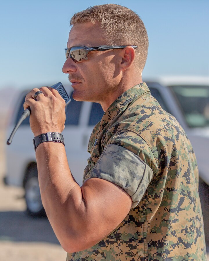 Gunnery Sgt. Nicholas Beberniss, Headquaters Company Gunnery Sgt., instructs Marines in the pits to raise targets during weapons qualification aboard Marine Corps Logistics Base Barstow, California, Sept. 13. (U.S. Marine Corps photo by Jack J. Adamyk)