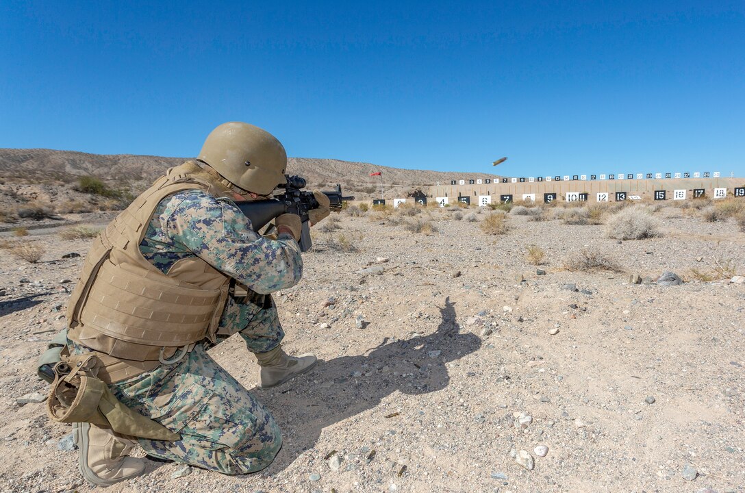 Sgt. Michael Sanchez, Field Radio Operator, transitions from the standing position to the kneeling, where he takes a controlled pair shot at his target during weapons qualification aboard Marine Corps Logistics Base Barstow, California, Sept. 13. (U.S. Marine Corps photo by Jack J. Adamyk)