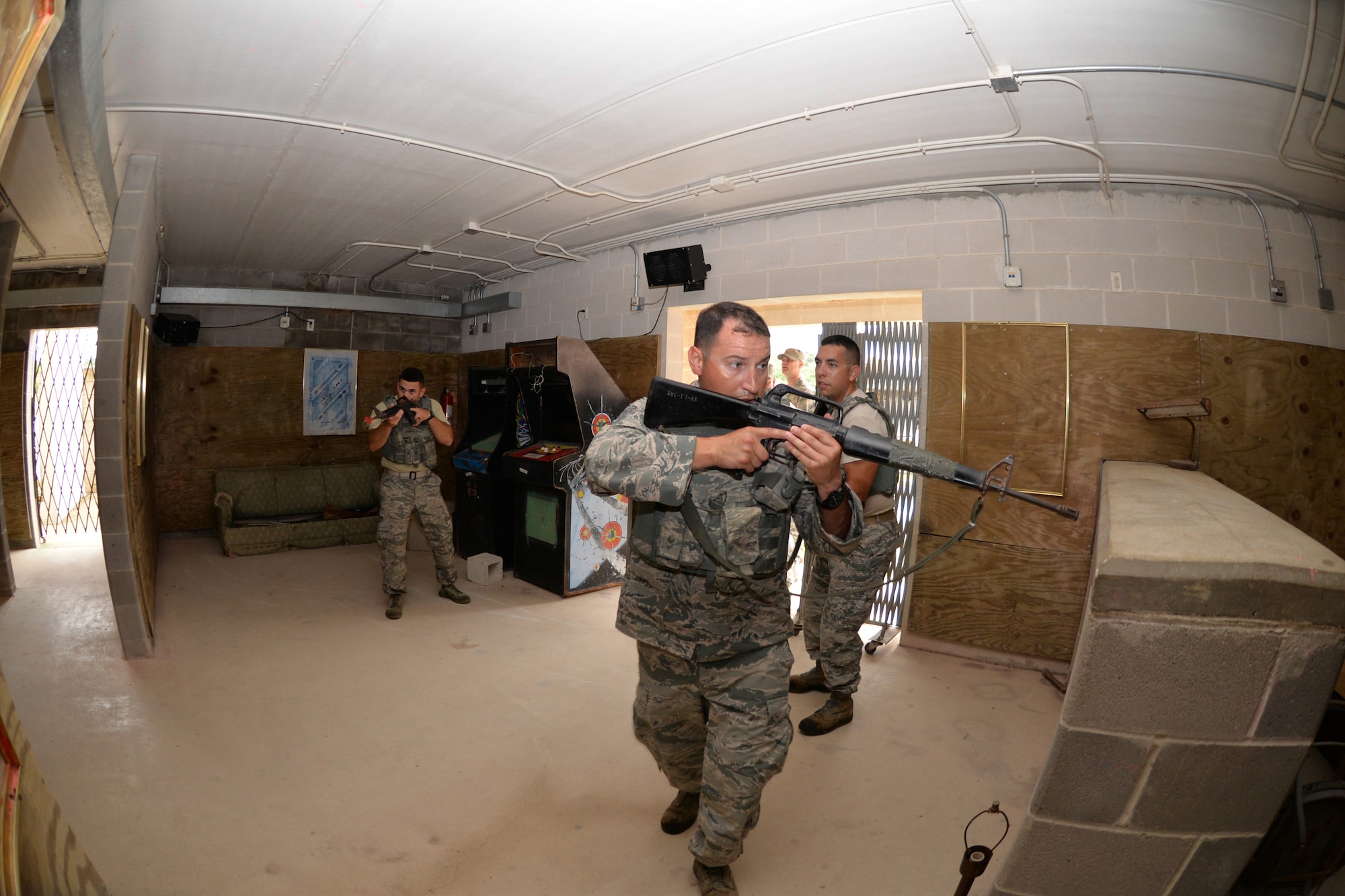 Air Force Reserve Command Defender Challenge Team Members Senior Airman Rick Cardona (left), and Tech Sgts. Francisco Gonzalez, and Hector Zamora, team leader, perform room-clearing exercises at Camp Bullis Military Training Reservation, Texas, Sept. 7, 2018.