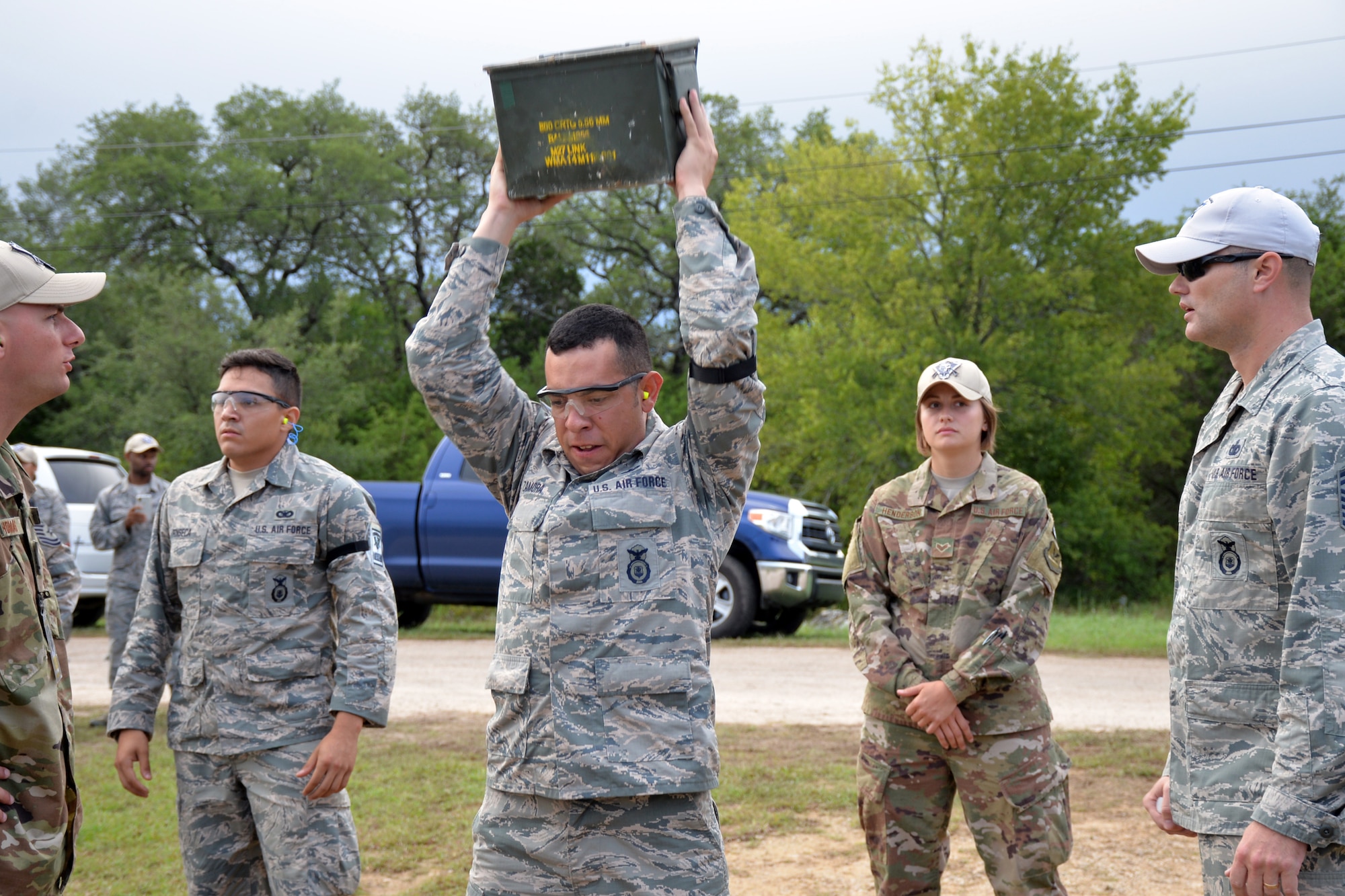 Tech Sgt. Hector Zamora, Air Force Reserve Command Defender Challenge team leader, performs 25 repetitions of lifting the ammo can as the first portion of his relay in the combat endurance event Sept. 13, 2018 at Camp Bullis Military Training Reservation, Texas.