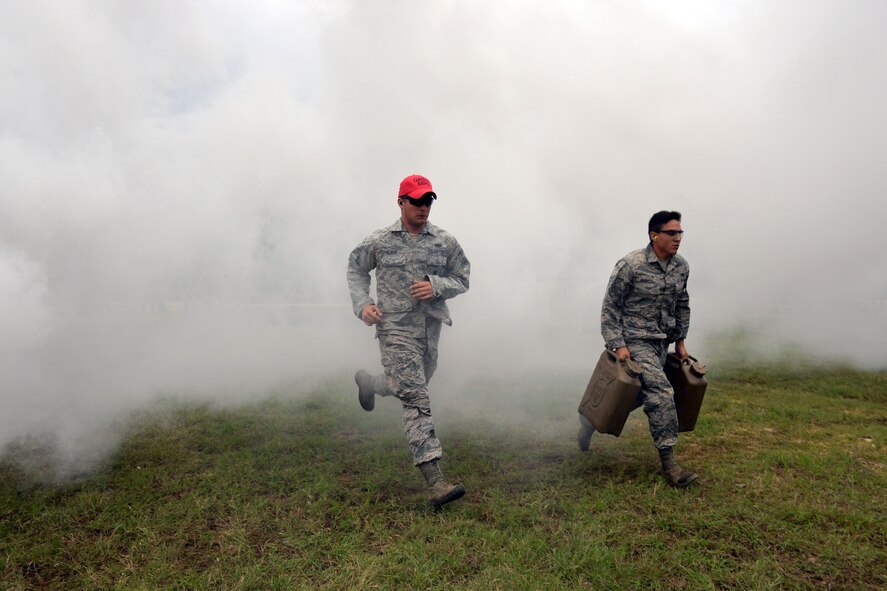Senior Airman Lorenzo Fonseca, Air Force Reserve Command Defender Challenge team member, carries Jerry cans filled with water 50 meters from the starting point to the next station where he will attempt to shoot a target with an M4 carbine rifle during the combat endurance relay Sept. 13, 2018 at Camp Bullis Military Training Reservation, Texas.