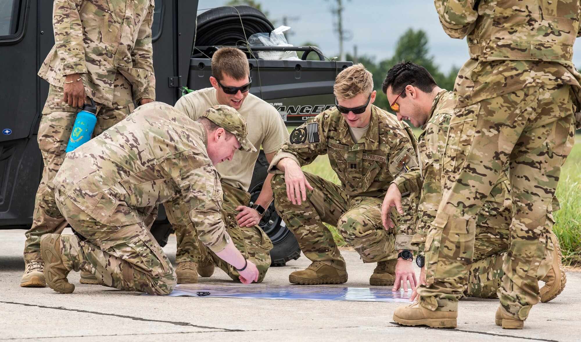 Alaska Air National Guard personnel from Joint Base Elmendorf-Richardson, Alaska,  look over a map Sept. 13, 2018, at Dover Air Force Base, Del. Members and equipment from the 176th Wing, 176th Aircraft Maintenance Squadron, 211th and 212th Rescue Squadrons at JBER  arrived at Dover on Sept. 12 to support hurricane relief efforts when called upon. (U.S. Air Force photo by Roland Balik)