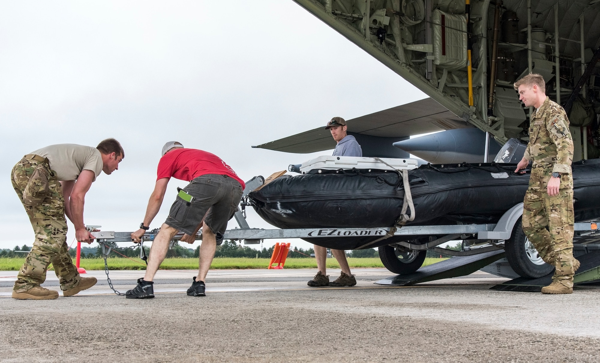 Alaska Air National Guard personnel offload a trailer carrying an inflatable rubber Zodiac boat from an HC-130J Combat King II assigned to the 176th Wing, Joint Base Elmendorf-Richardson, Alaska, Sept. 14, 2018, at Dover Air Force Base, Del. Members and equipment from the 176th Aircraft Maintenance Squadron, 211th and 212th Rescue Squadrons arrived at Dover AFB on Sept. 12 to support hurricane relief efforts when called upon. (U.S. Air Force photo by Roland Balik)