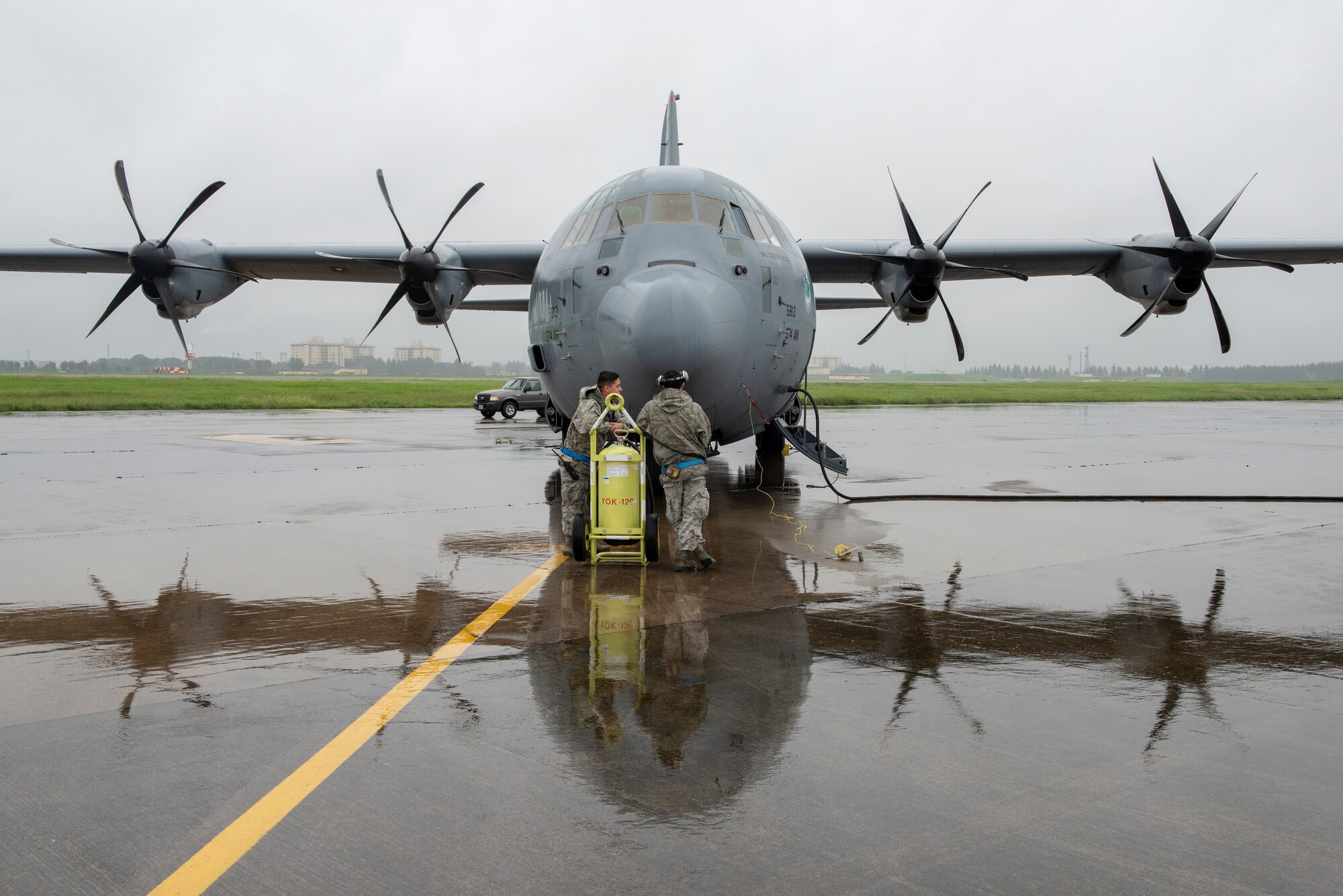 Crew chiefs with the 374th Aircraft Maintenance Squadron stand by as the crew of a C-130J Super Hercules prepare to start their engines prior to a low-cost, low-altitude demonstration at the 2018 Japanese-American Friendship Festival at Yokota Air Base, Japan, Sept. 15, 2018.