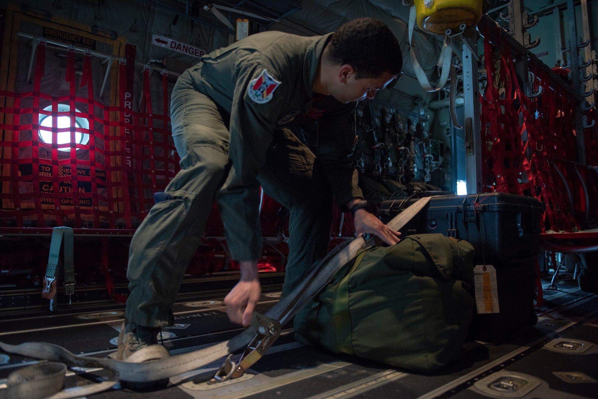 Staff Sgt. Brian Gates, 36th Airlift Squadron loadmaster, secures equipment in a C-130J Super Hercules prior to a low-cost, low-altitude demonstration at the 2018 Japanese-American Friendship Festival at Yokota Air Base, Japan, Sept. 15, 2018.