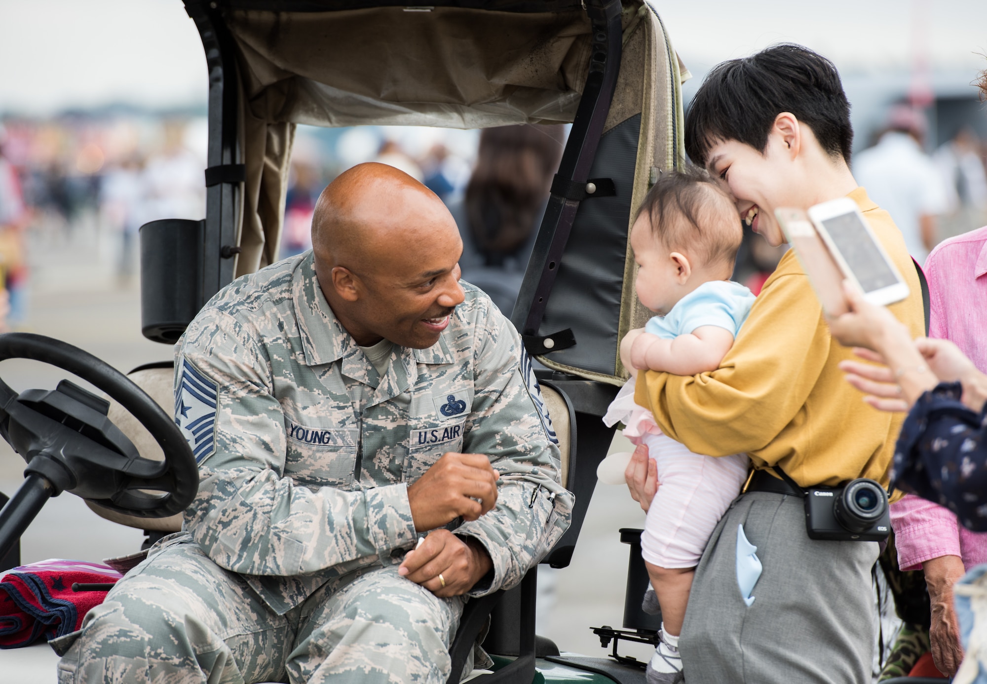 Chief Master Sgt. Elvin Young, 374th Airlift Wing command chief, introduces himself to a family