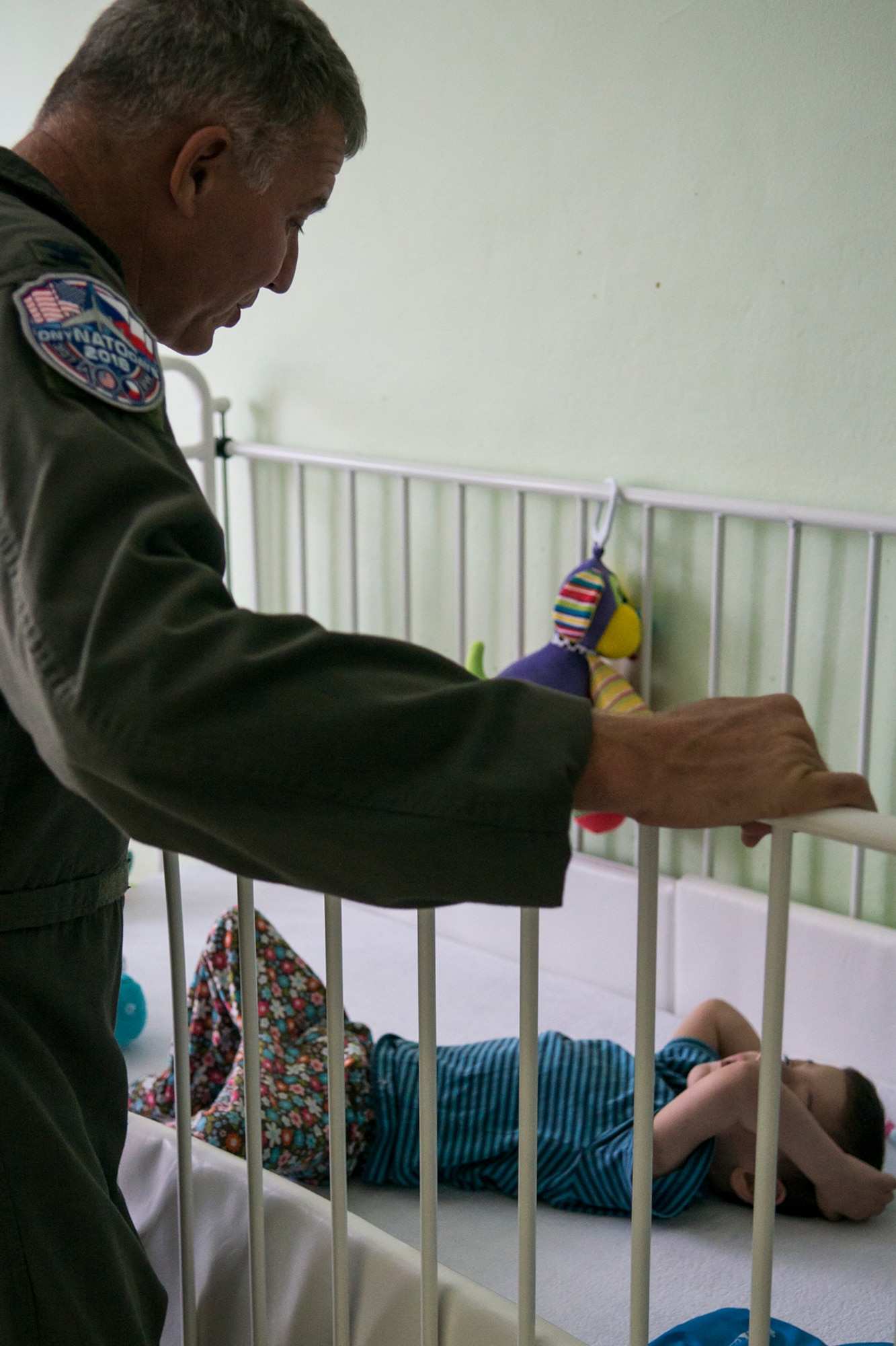 U.S. Air Force Reserve Col. Robert VanHoy, 307th Bomb Wing commander, visits a terminally ill child at the Children’s Center orphanage on Sept 13, 2018, Ostrava, Czech Republic. VanHoy is in Ostrava to support the NATO Days air show, and as with years past, members of the 307th BW have always made time to visit the center. (U.S. Air Force photo by Master Sgt. Greg Steele)