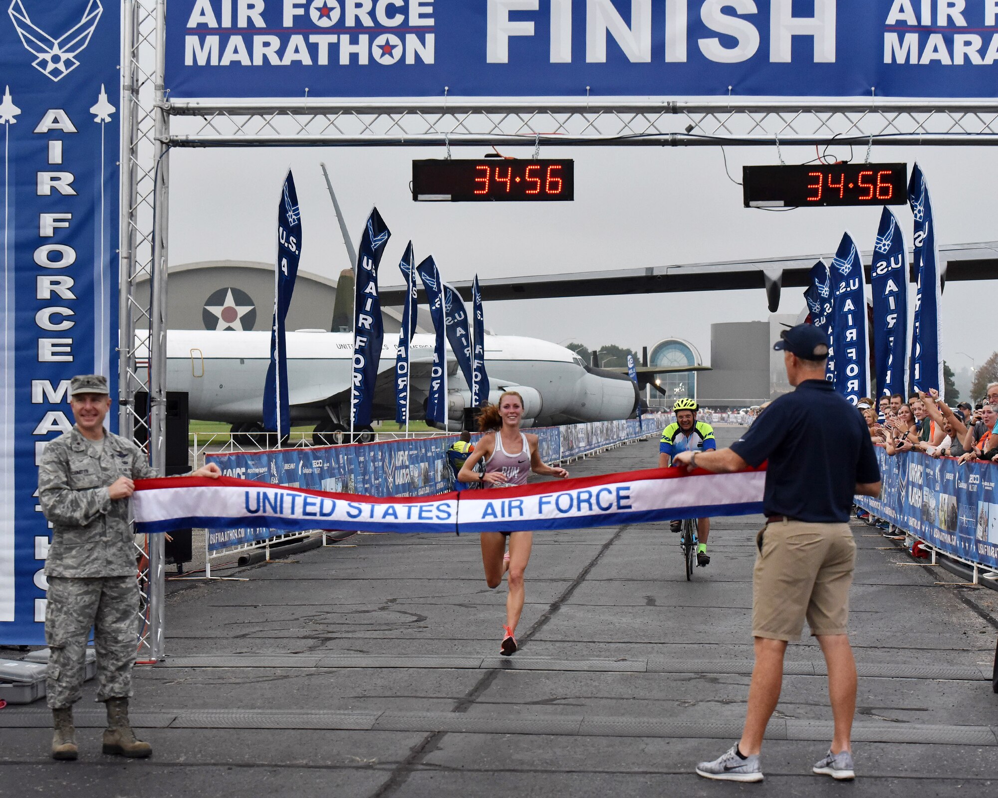 Ann Alyanak crosses the finish line of the Air Force Marathon 5K race at Wright State University in Fairborn, Ohio on Sept. 14, 2018. Alyank, from Bellbrook, Ohio, won the women's division with a time of 18:28. (U.S. Air Force photo / R.J. Oriez