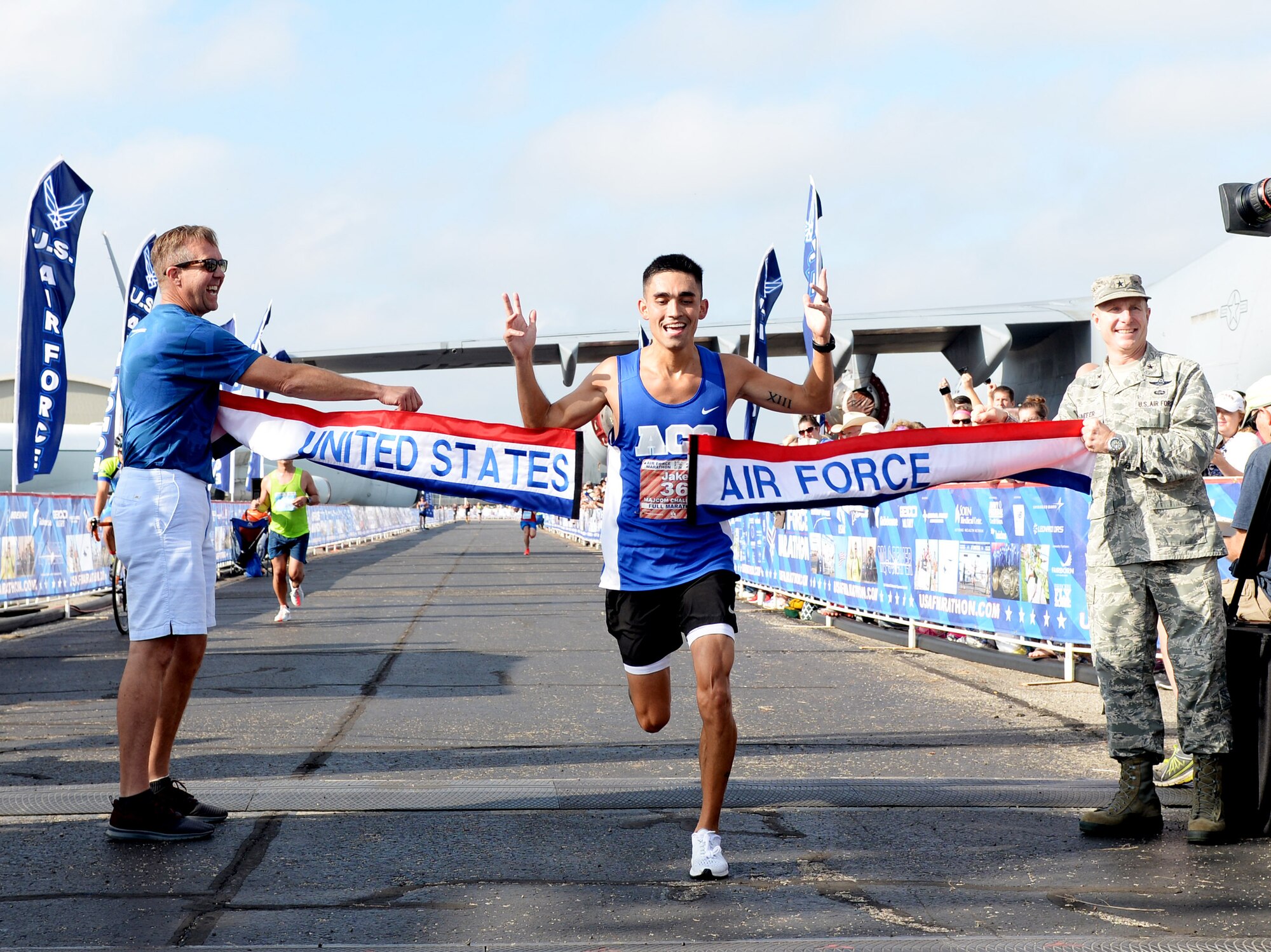 SSgt Jacob McCubbin crosses the finish line of the Air Force Marathon full marathon at Wright-Patterson Air Force Base on Sept. 15, 2018.  McCubbin, from San Antonio, Texas, won the men's division with a time of  2:35:57. (U.S. Air Force photo / Wesley Farnsworth)