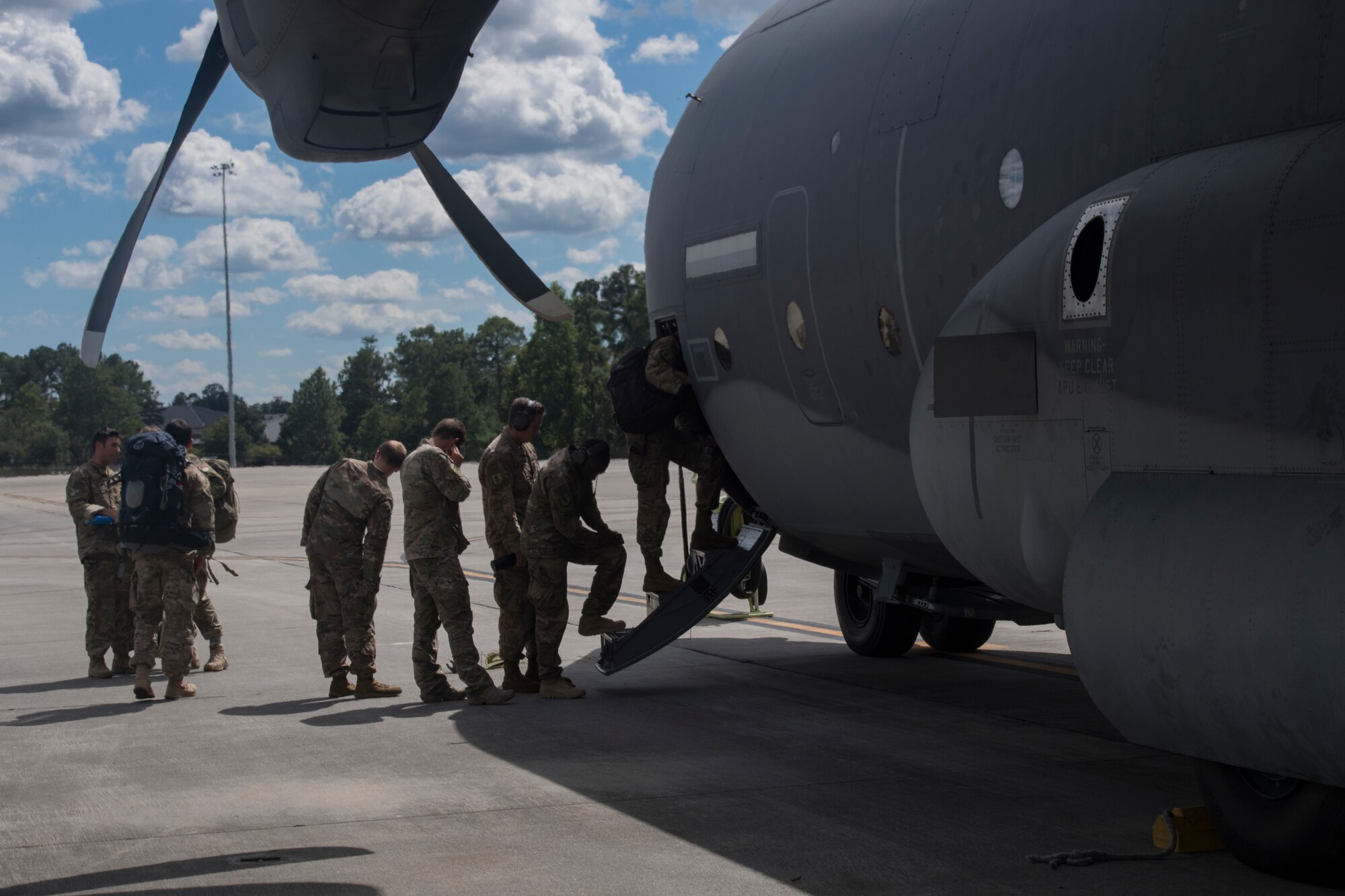 Airmen from the 71st Rescue Squadron board a HC-130J Combat King II, Sept. 15, 2018, at Moody Air Force Base, Ga. The 334th Air Expeditionary Group launched HC-130J Combat King IIs, HH-60G Pavehawks, aircrew and support personnel to pre-position at Joint Base Charleston, S.C., for potential Tropical Storm Florence response. Under the command of Col. John Creel, the 374th Rescue Group commander, the AEG integrated to make one expeditionary search and rescue unit comprised of rescue and support personnel from both the 23d Wing, 920th Rescue Wing at Patrick Air Force Base, Fla., and 51st Communications Squadron at Warner Robins Air Force Base, Ga.  (U.S. Air Force photo by Staff Sgt. Eric Summers Jr.)
