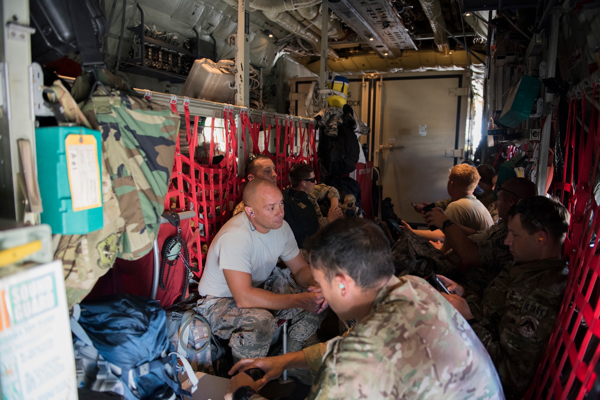 Airmen wait to depart on a HC-130J Combat King II, Sept. 15, 2018, at Moody Air Force Base, Ga. The 334th Air Expeditionary Group launched HC-130J Combat King IIs, HH-60G Pavehawks, aircrew and support personnel to pre-position at Joint Base Charleston, S.C., for potential Tropical Storm Florence response. Under the command of Col. John Creel, the 374th Rescue Group commander, the AEG integrated to make one expeditionary search and rescue unit comprised of rescue and support personnel from both the 23d Wing, 920th Rescue Wing at Patrick Air Force Base, Fla., and 51st Communications Squadron at Warner Robins Air Force Base, Ga.  (U.S. Air Force photo by Staff Sgt. Eric Summers Jr.)