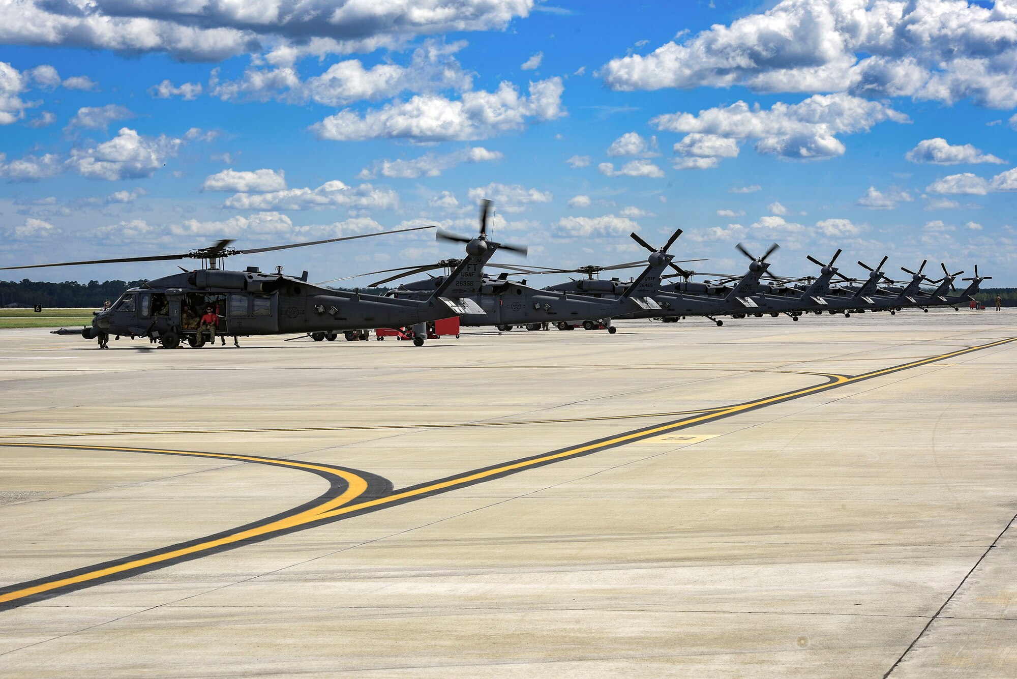 HH-60G Pavehawk helicopters position for departure in support Tropical Storm Florence relief operations, Sept. 15, 2018, at Moody Air Force Base, Ga. The 334th Air Expeditionary Group launched HC-130J Combat King IIs, HH-60G Pavehawks, aircrew and support personnel to pre-position at Joint Base Charleston, S.C., for potential Tropical Storm Florence response. Under the command of Col. John Creel, the 374th Rescue Group commander, the AEG integrated to make one expeditionary search and rescue unit comprised of rescue and support personnel from both the 23d Wing, 920th Rescue Wing at Patrick Air Force Base, Fla., and 51st Combat Communications Squadron at Robins Air Force Base, Ga. (U.S. Air Force photo by Senior Airman Greg Nash)