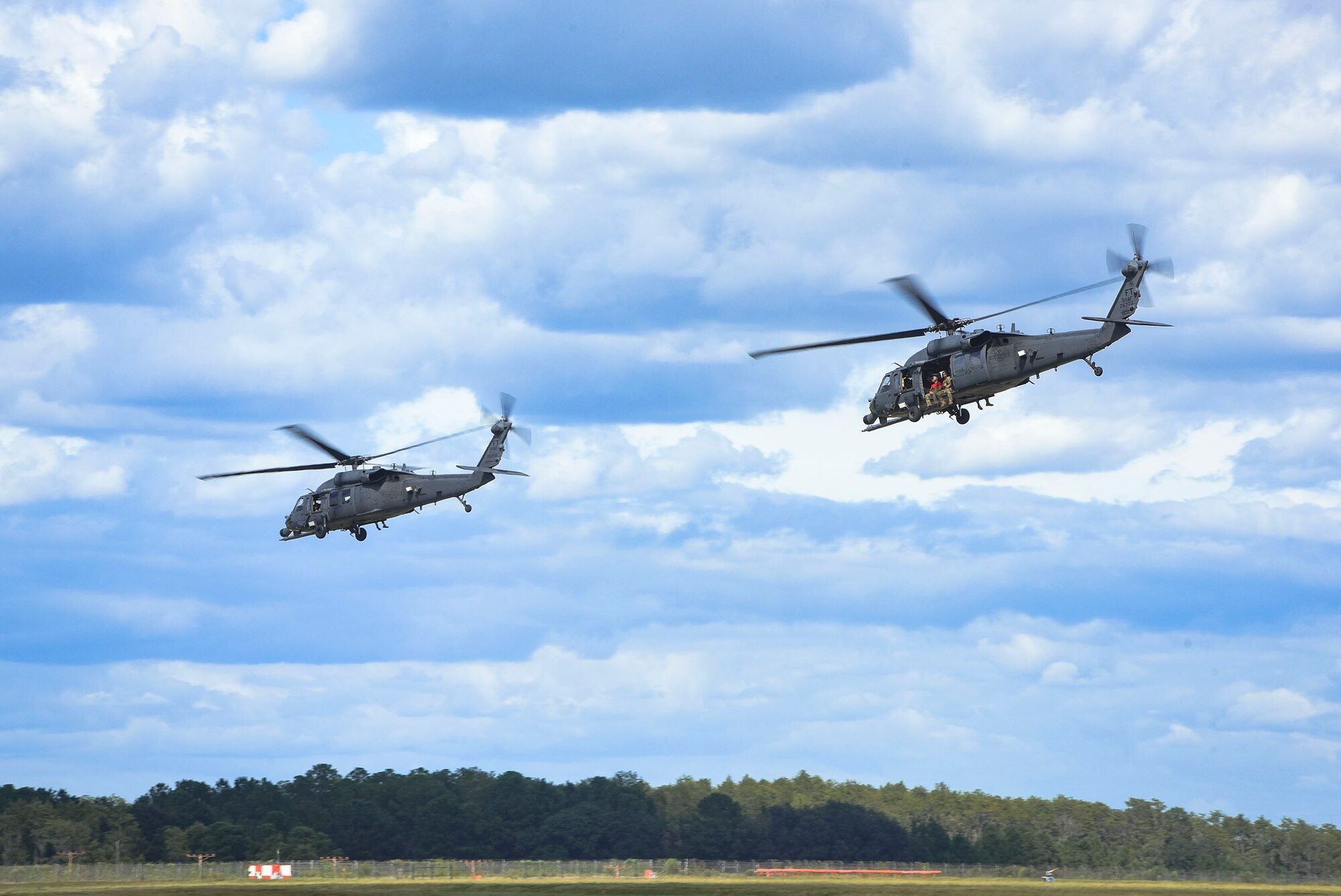 HH-60G Pavehawk helicopters launch in support of Tropical Storm Florence relief operations, Sept. 15, 2018, at Moody Air Force Base, Ga. The 334th Air Expeditionary Group launched HC-130J Combat King IIs, HH-60G Pavehawks, aircrew and support personnel to pre-position at Joint Base Charleston, S.C., for potential Tropical Storm Florence response. Under the command of Col. John Creel, the 374th Rescue Group commander, the AEG integrated to make one expeditionary search and rescue unit comprised of rescue and support personnel from both the 23d Wing, 920th Rescue Wing at Patrick Air Force Base, Fla., and 51st Combat Communications Squadron at Robins Air Force Base, Ga. (U.S. Air Force photo by Senior Airman Greg Nash)