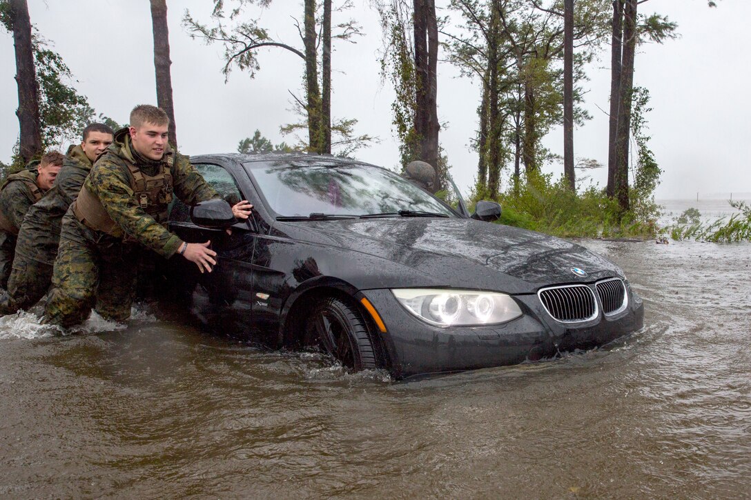 180915-M-JQ384-009
CAMP LEJEUNE, N.C. (Sept. 15, 2018) Marines from Marine Corps Base Camp Lejeune help push a car out of a flooded area during Hurricane Florence on Marine Corps Base Camp Lejeune, Sept. 15, 2018. Hurricane Florence impacted Marine Corps Base Camp Lejeune and Marine Corps Air Station New River with periods of strong winds, heavy rains, flooding of urban and low lying areas, flash floods and coastal storm surges. (U.S. Marine Corps photo by Lance Cpl. Isaiah Gomez/Released)