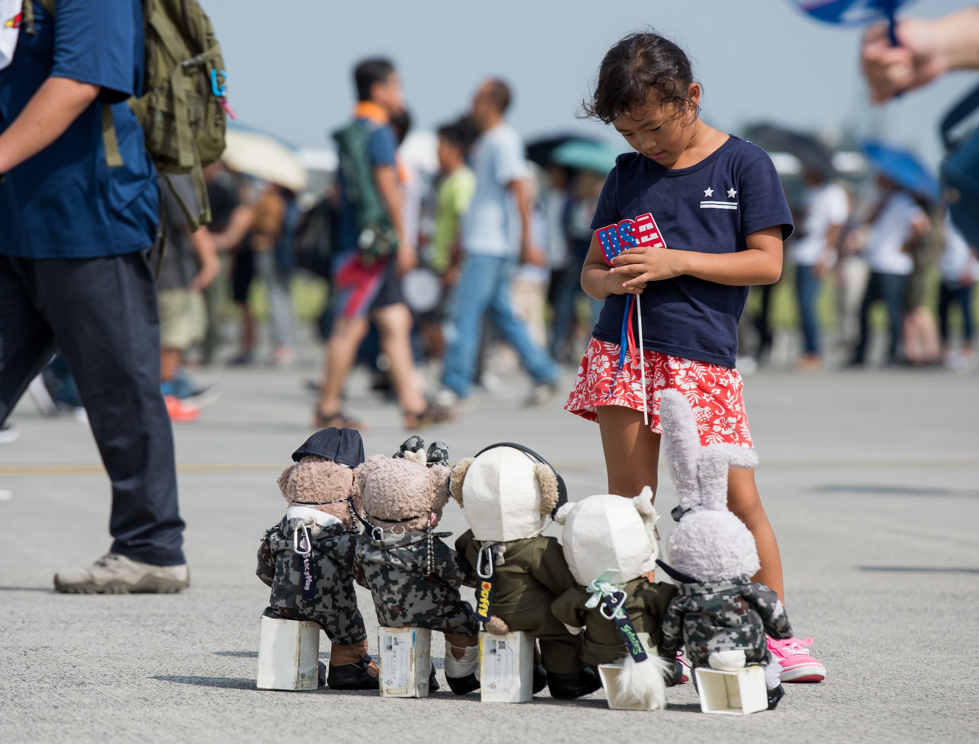 A girl looks at stuffed animals
