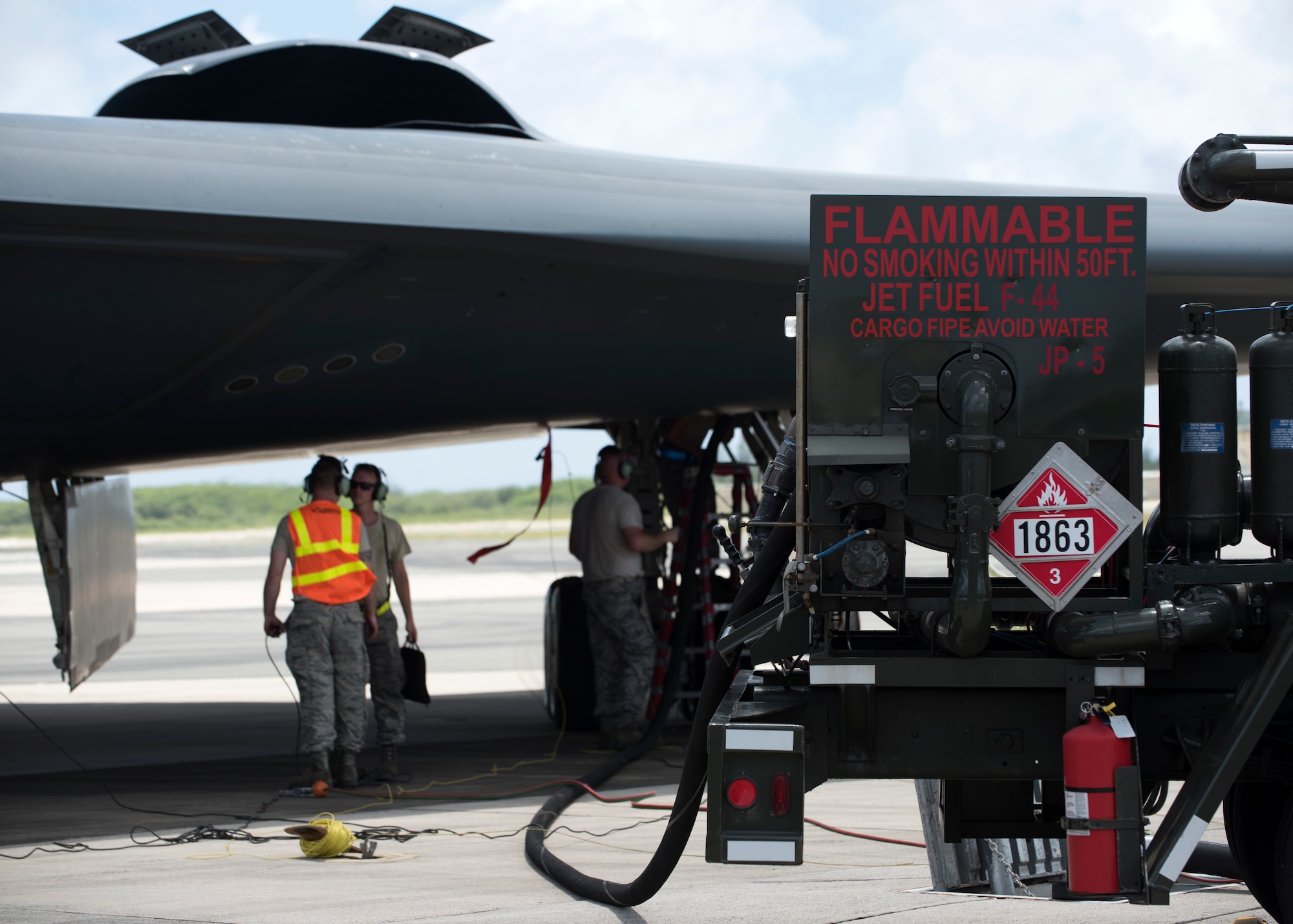 Crew chiefs and a fuel distribution operator deployed from Whiteman Air Force Base, Missouri, conduct hot-pit refueling on a B-2 Spirit at Wake Island Airfield Sept. 14, 2018.