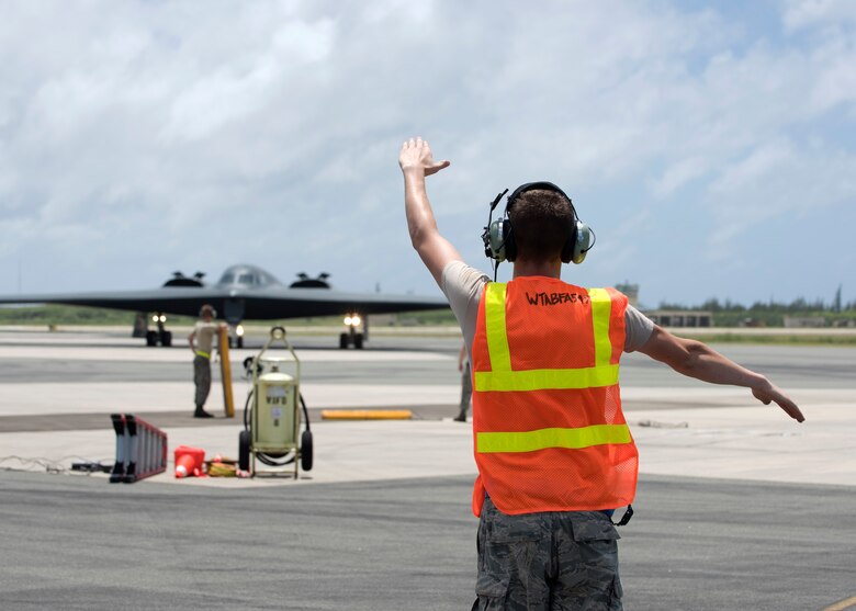 U.S. Air Force Staff Sgt. Hayden Thayer, crew chief deployed from Whiteman Air Force Base, Missouri, marshals a B-2 Spirit at Wake Island Airfield Sept. 14, 2018.