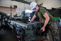 Cpl. Salvatore Ferrigno aligns a cannon tube during the reassembly of a M777 A2 Medium Towed Howitzer Sept. 14, 2018, at Camp Hansen, Okinawa, Japan. Armament Repair Platoon repairs weapons in support of 3rd Battalion, 12th Marine Regiment, 3rd Marine Division to ensure the safety of the Marines operating the weapons. Ferrigno is a machinist with Armament Repair Platoon, Ordnance Maintenance Company, 3rd Maintenance Battalion, Combat Logistics Regiment 35, 3rd Marine Logistics Group, and is a native of Barnegat, New Jersey. (U.S. Marine Corps photo by Pfc. Terry Wong)