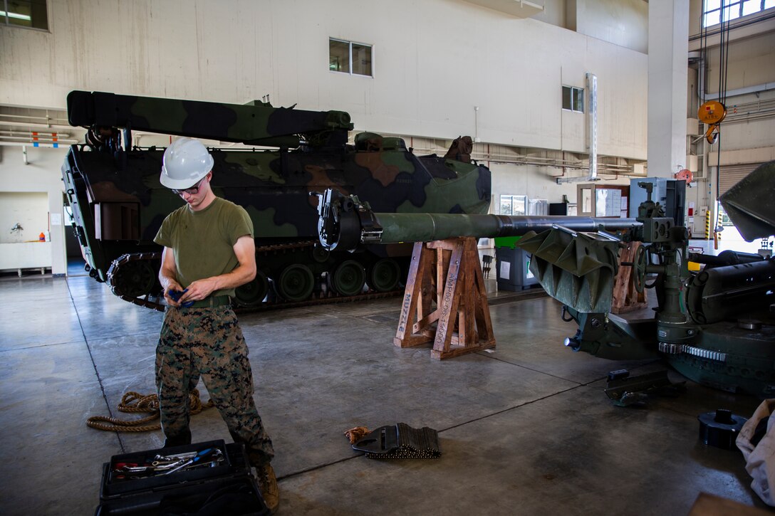 Lance Cpl. Sidney Vanderhook prepares equipment during the reassembly of a M777 A2 Medium Towed Howitzer Sept. 14, 2018, at Camp Hansen, Okinawa, Japan. Armament Repair Platoon repairs weapons in support of 3rd Battalion, 12th Marine Regiment, 3rd Marine Division to ensure the safety of the Marines operating the weapons. Vanderhook is an artillery mechanic with Armament Repair Platoon, Ordnance Maintenance Company, 3rd Maintenance Battalion, Combat Logistics Regiment 35, 3rd Marine Logistics Group, and is a native of Southaven, Mississippi. (U.S. Marine Corps photo by Pfc. Terry Wong)