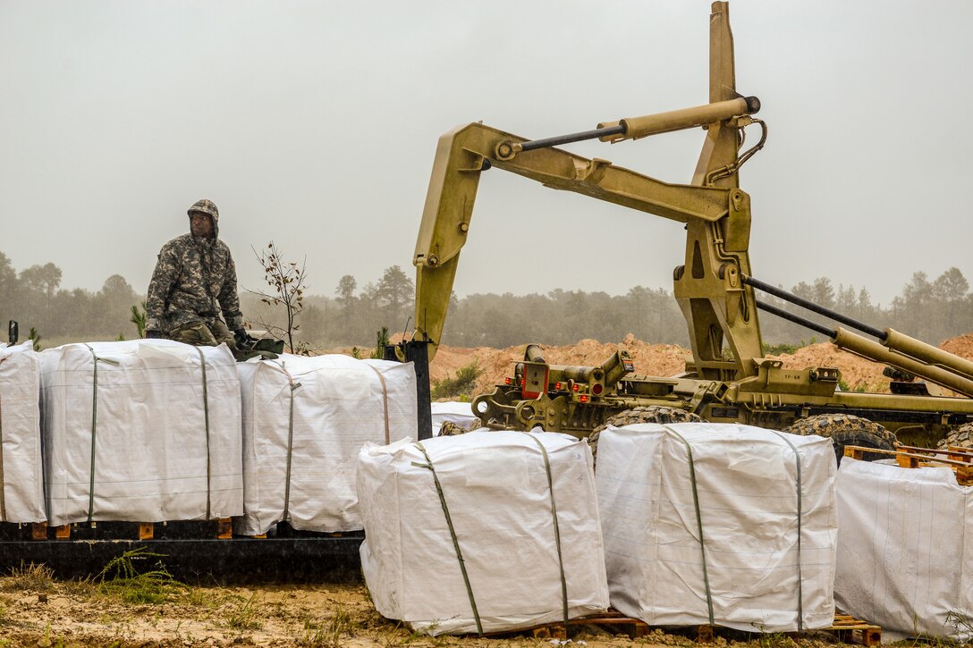 A Soldier with the South Carolina Army National Guard pauses for a moment while working with and the South Carolina Department of Transportation to fill sandbags as a result of flooding caused by Tropical Storm Florence, Sept. 15, 2018. Approximately 3,200 Soldiers and Airmen have been mobilized to prepare, respond and participate in recovery efforts as forecasters project Tropical Storm Florence has the potential to cause flooding and projected to damage the state as the storm makes landfall near the Carolinas and east coast.
