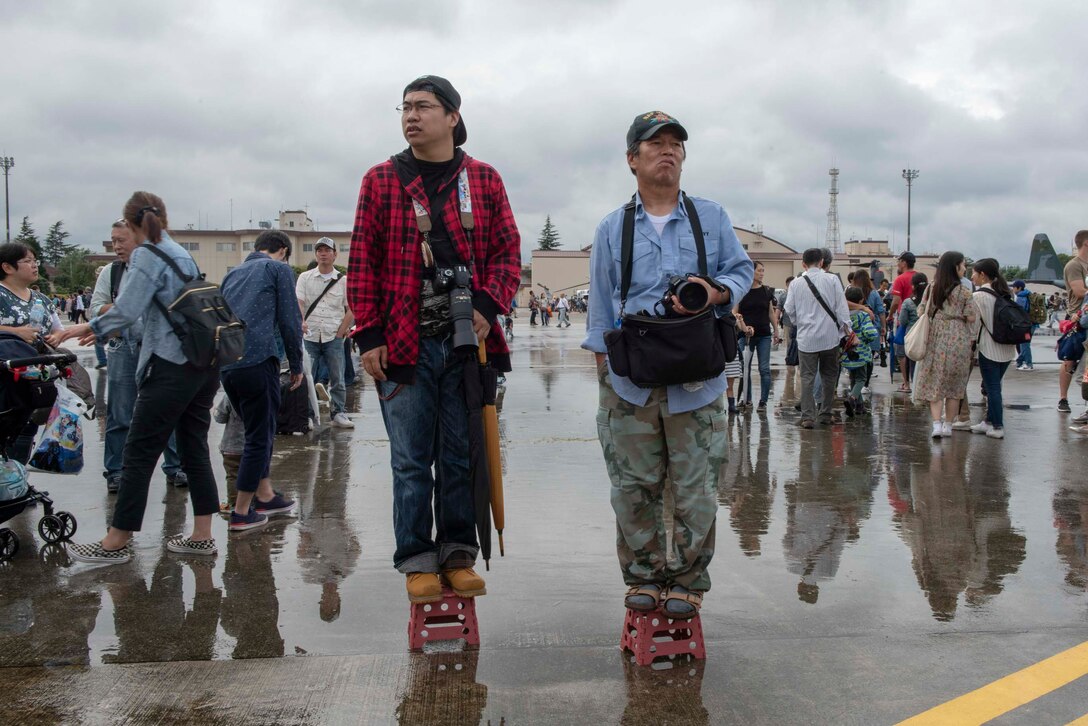 A pair of festivalgoers stand in waiting for the next aerial demonstration at the 2018 Japanese-American Friendship Festival at Yokota Air Base, Japan, Sept. 15, 2018.