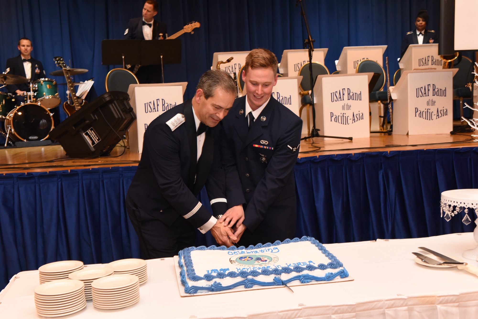 U.S. Air Force Lt. Gen. Kenneth S. Wilsbach, Seventh Air Force commander, and U.S. Air Force Airman Marcus Davidson, assigned to the 51st Civil Engineer Squadron fire and emergency services flight, use a ceremonial sword to cut the cake during an Air Force 71st Birthday Ball at Osan Air Base, Republic of Korea, September 15, 2018.