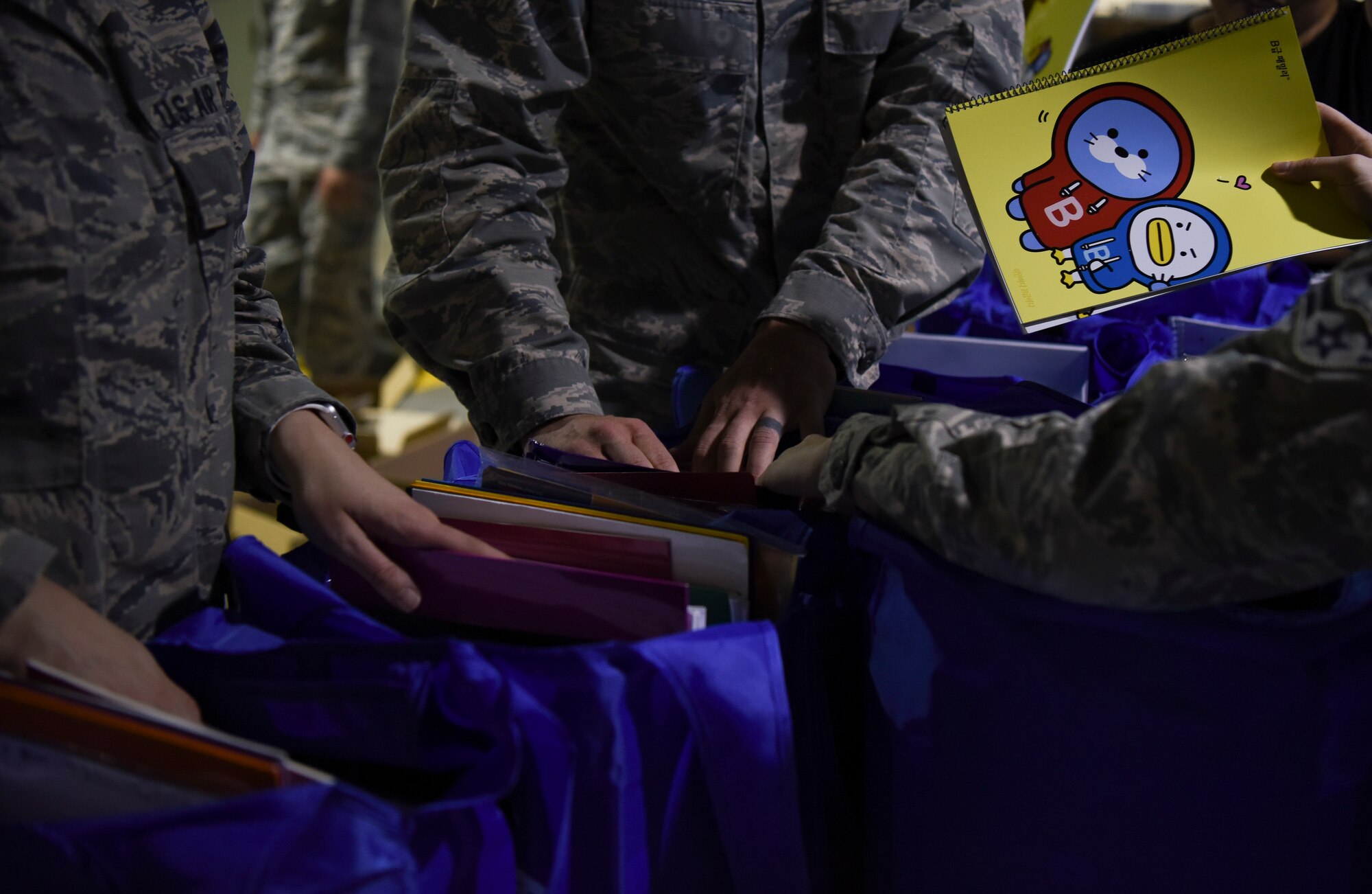 Airmen from the 8th Logistics Readiness Squadron sort through donations collected during a Back to School Drive at Kunsan Air Base, Republic of Korea, Sept. 13, 2018. The base wide drive received more than 400 books and over 5,000 dollars in school supplies for local schools. (U.S. Air Force photo by Senior Airman Savannah L. Waters)