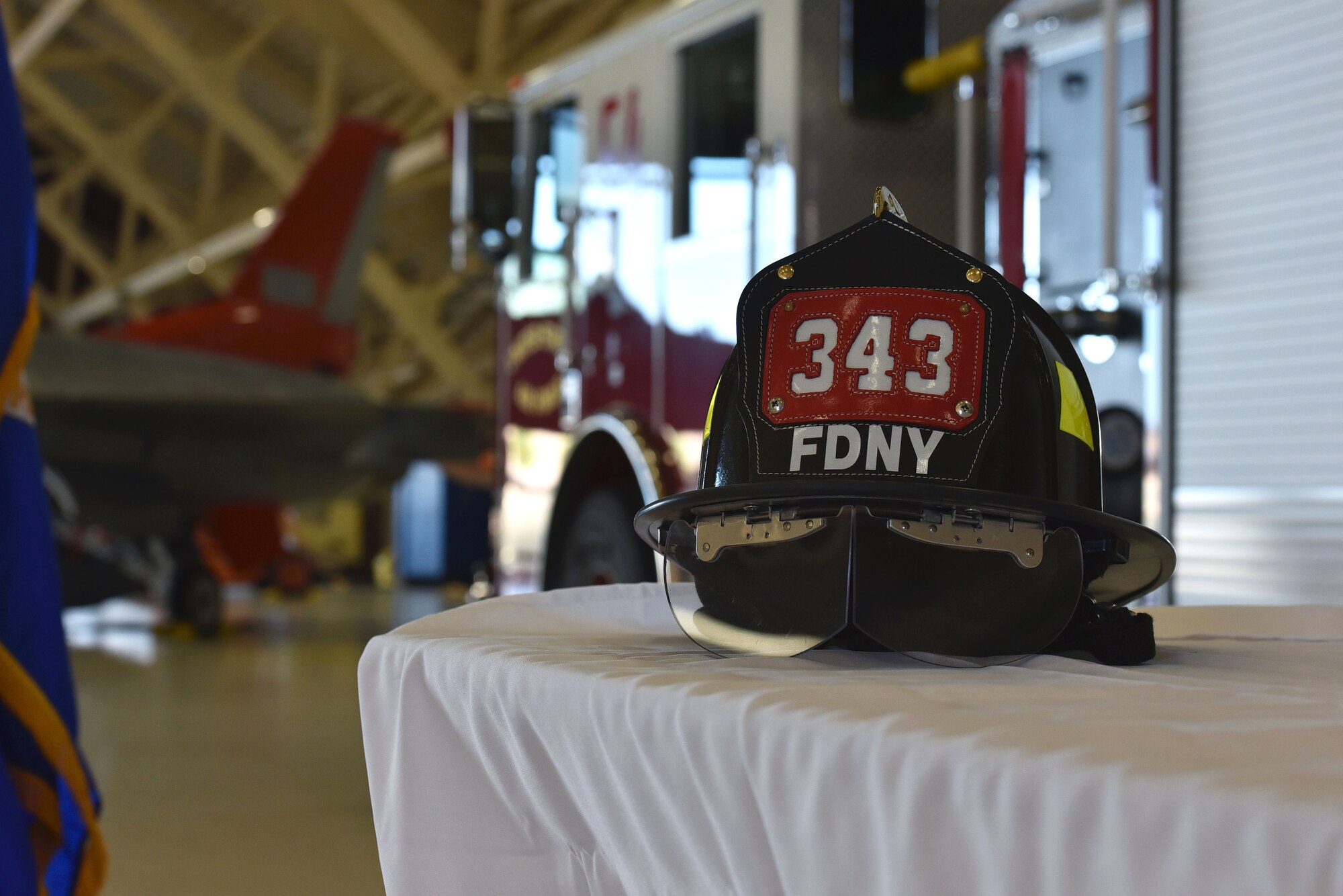 A firefighter’s helmet sits on display at a 9/11 remembrance ceremony in Hangar 5 at Tyndall Air Force Base, Fla., Sept. 11, 2018. In addition to several symbolic items being placed for viewing, members of Team Tyndall leadership spoke during the event about what 9/11 means to them and what affect it had on their lives. (U.S. Air Force photo by Airman 1st Class Miranda M.B. Simpson)