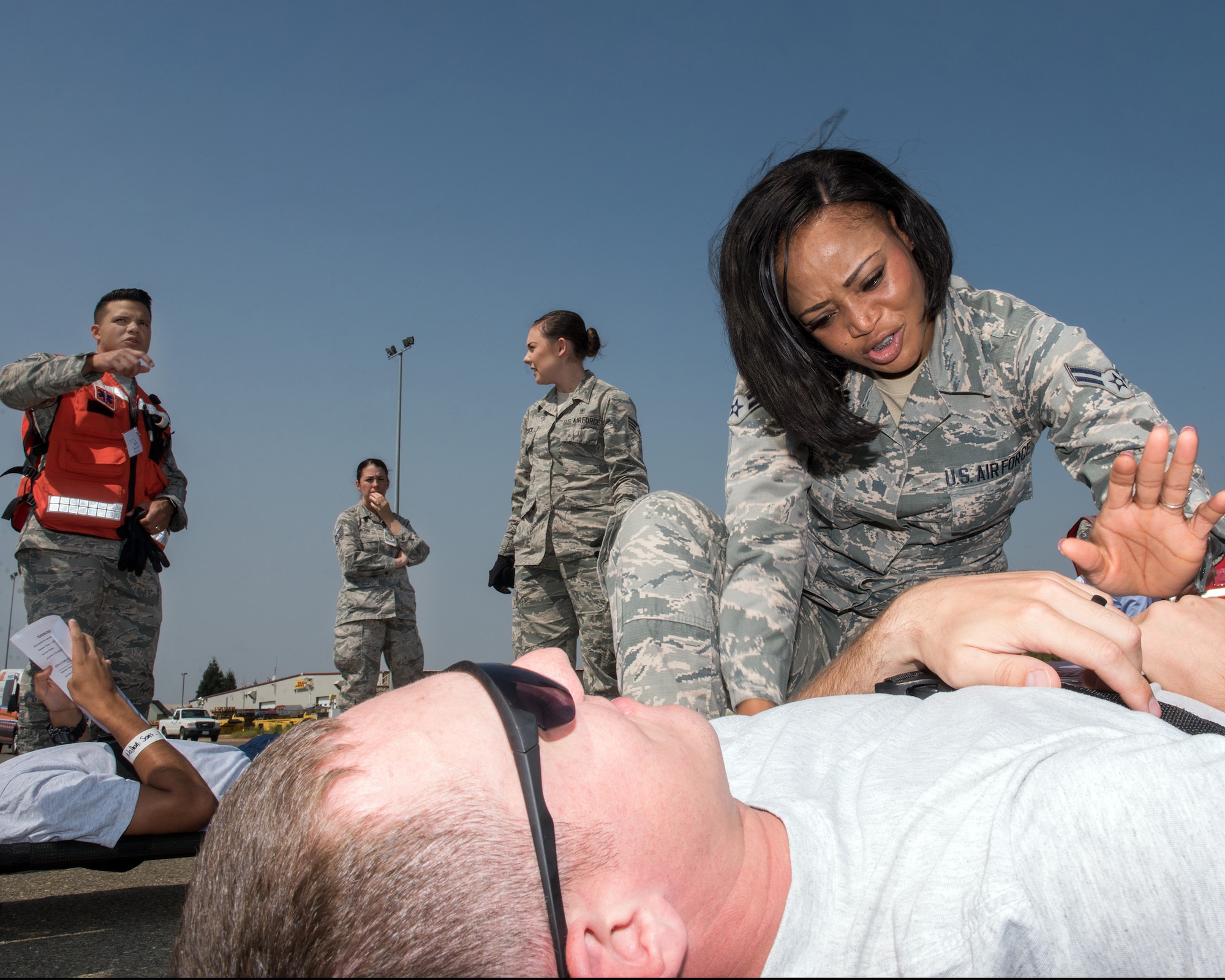 U.S. Air Force Airman 1st Class Adejoke Akodu, 60th Aerospace Medicine Squadron, Travis Air Force Base, California, treats a simulated patient during Exercise Ultimate Caduceus 2018 at Mather Airport, Sacramento, California, Aug. 23, 2018. Ultimate Caduceus 2018 is an annual patient movement exercise designed to test the ability of U.S. Transportation Command to provide medical evacuation. (U.S. Air Force photo by Louis Briscese)