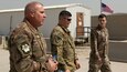 U.S. Army Capt. Joshua Paille, middle, commander of Headquarters and Headquarters Detachment 1109th Theater Aviation Sustainment Maintenance Group, attached to Task Force 22, leads his father, U.S. Air Force Chief Master Sgt. Andre Paille, a project manager with the 214th Engineering Installation Squadron, Louisiana Air National Guard, attached to U.S. Air Force Central, left, and his former college classmate, U.S. Army Capt. Joseph Booth, commander of the 220th Public Affairs Detachment, attached to U.S. Army Central, on a tour of the airfield where he works at Camp Arifjan, Kuwait, Sept. 1, 2018. One of the greatest assets available to the Army are Soldiers and their families who continue a rich tradition of military service.